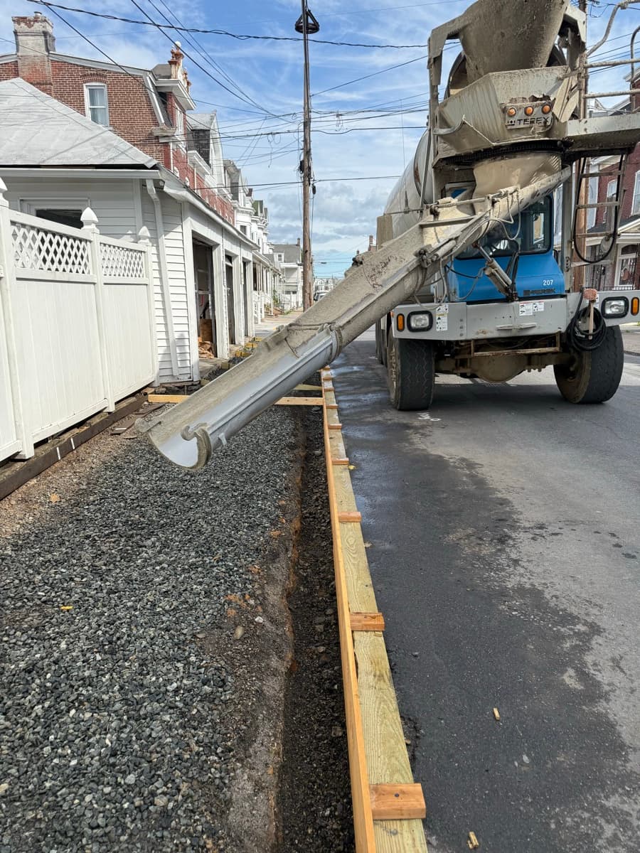 Side-yard path under construction beside a house