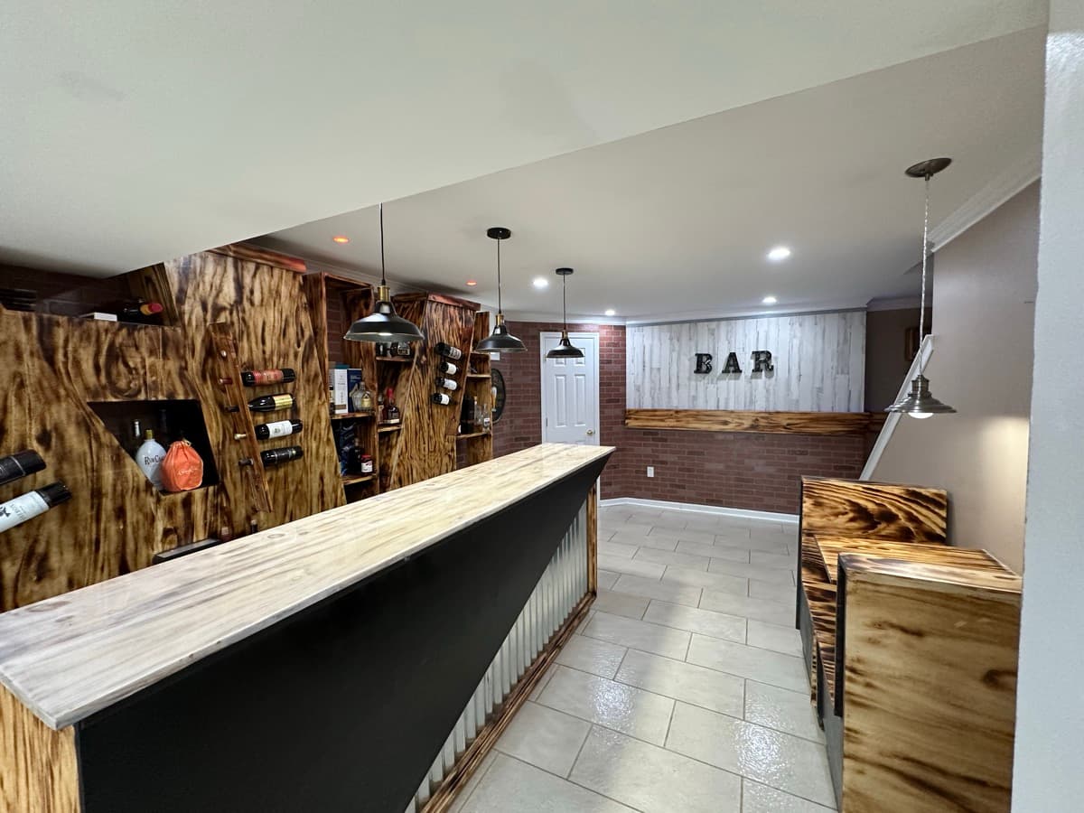 Finished basement bar with wood wall detailing