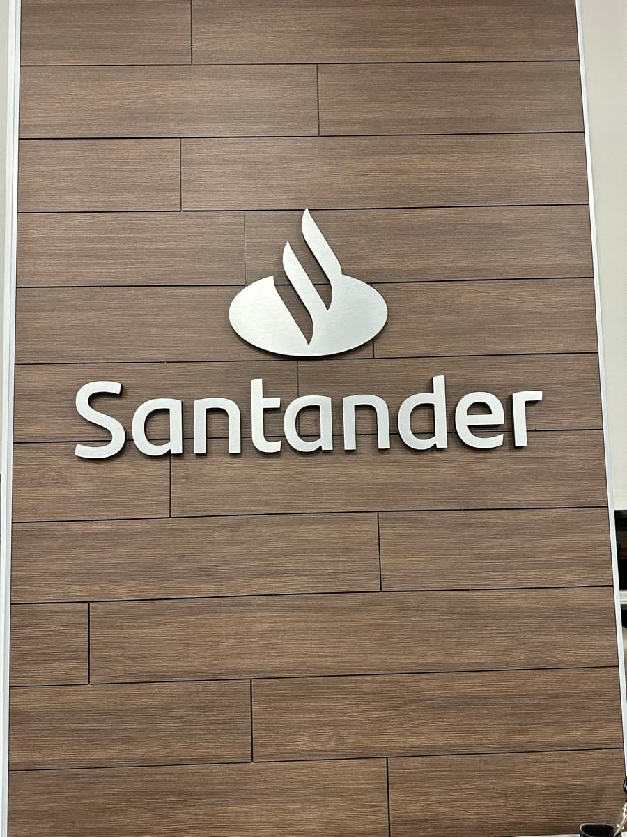 Santander feature wall with finished wood-look surface and brand sign