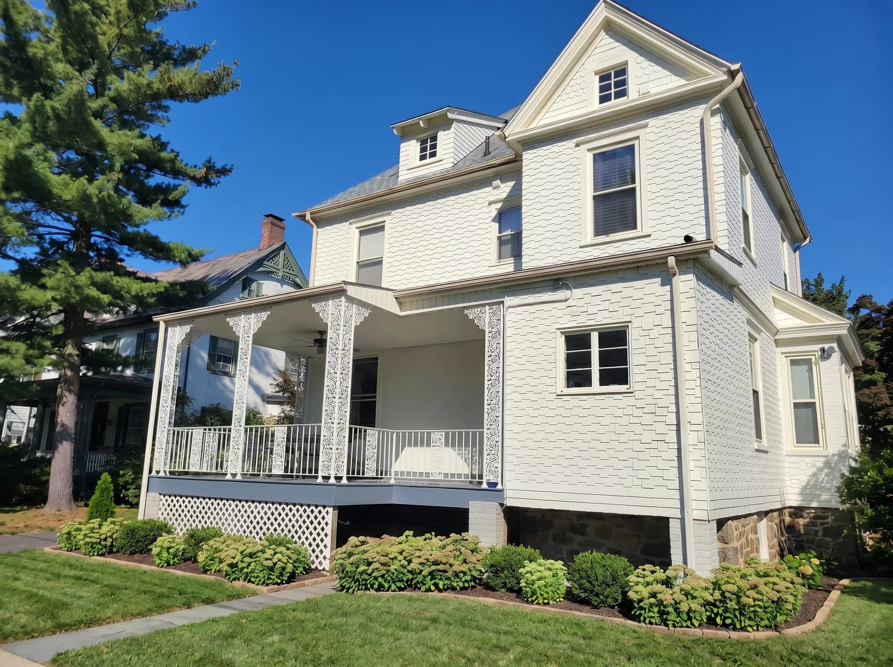 Finished exterior house painting in Bethlehem PA with white finish and covered front porch