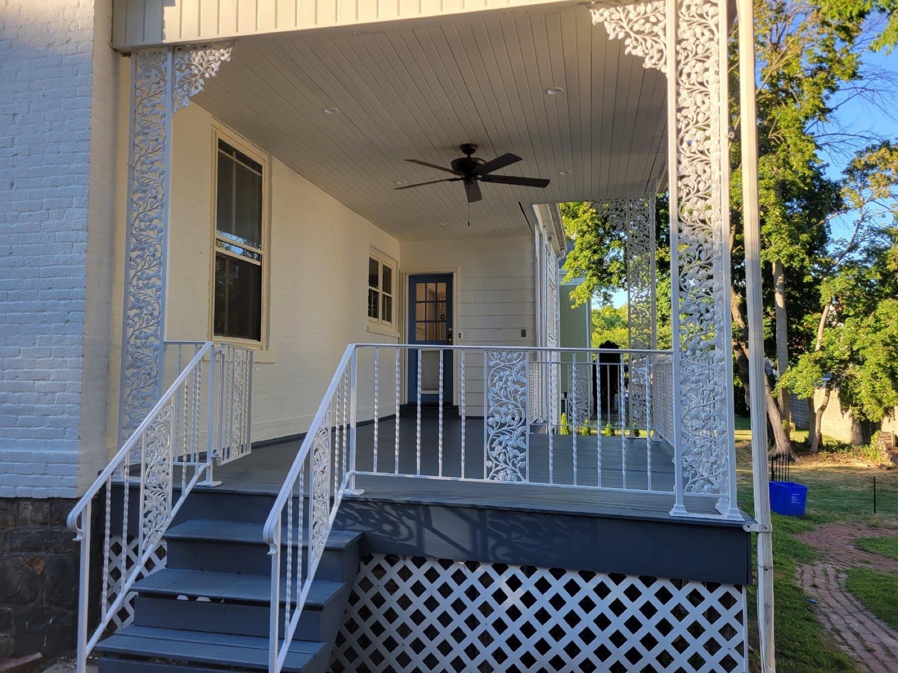 Finished Bethlehem porch with gray floor white railings and refreshed exterior paint