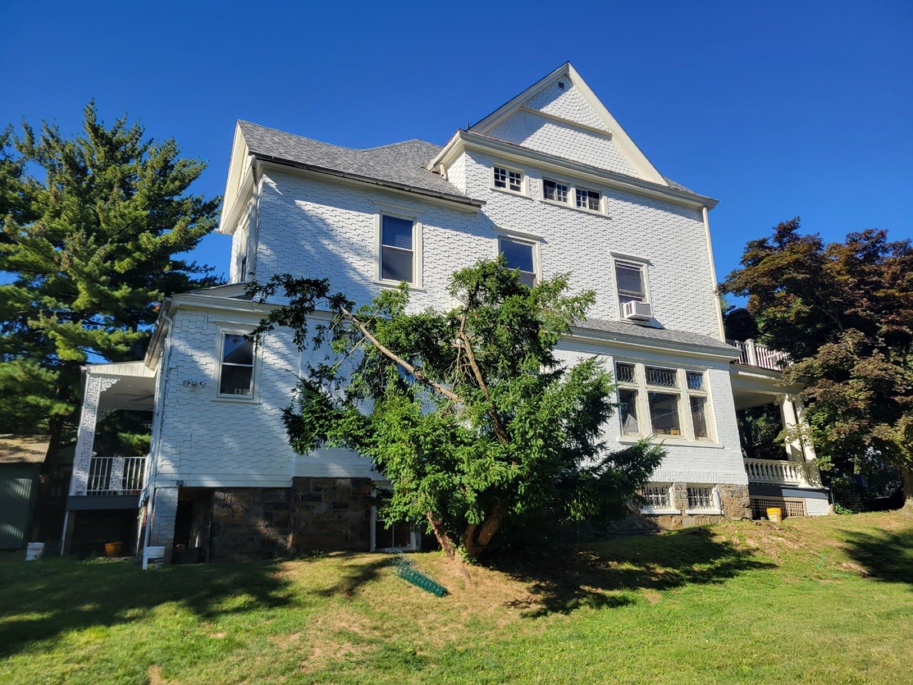 Finished rear exterior house painting in Bethlehem PA with stone foundation