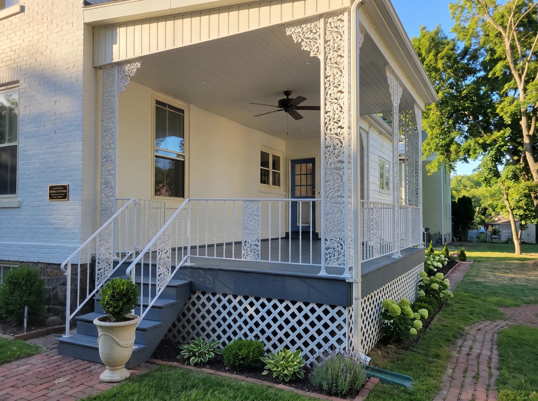 Finished Bethlehem side porch with white decorative iron posts and gray painted steps