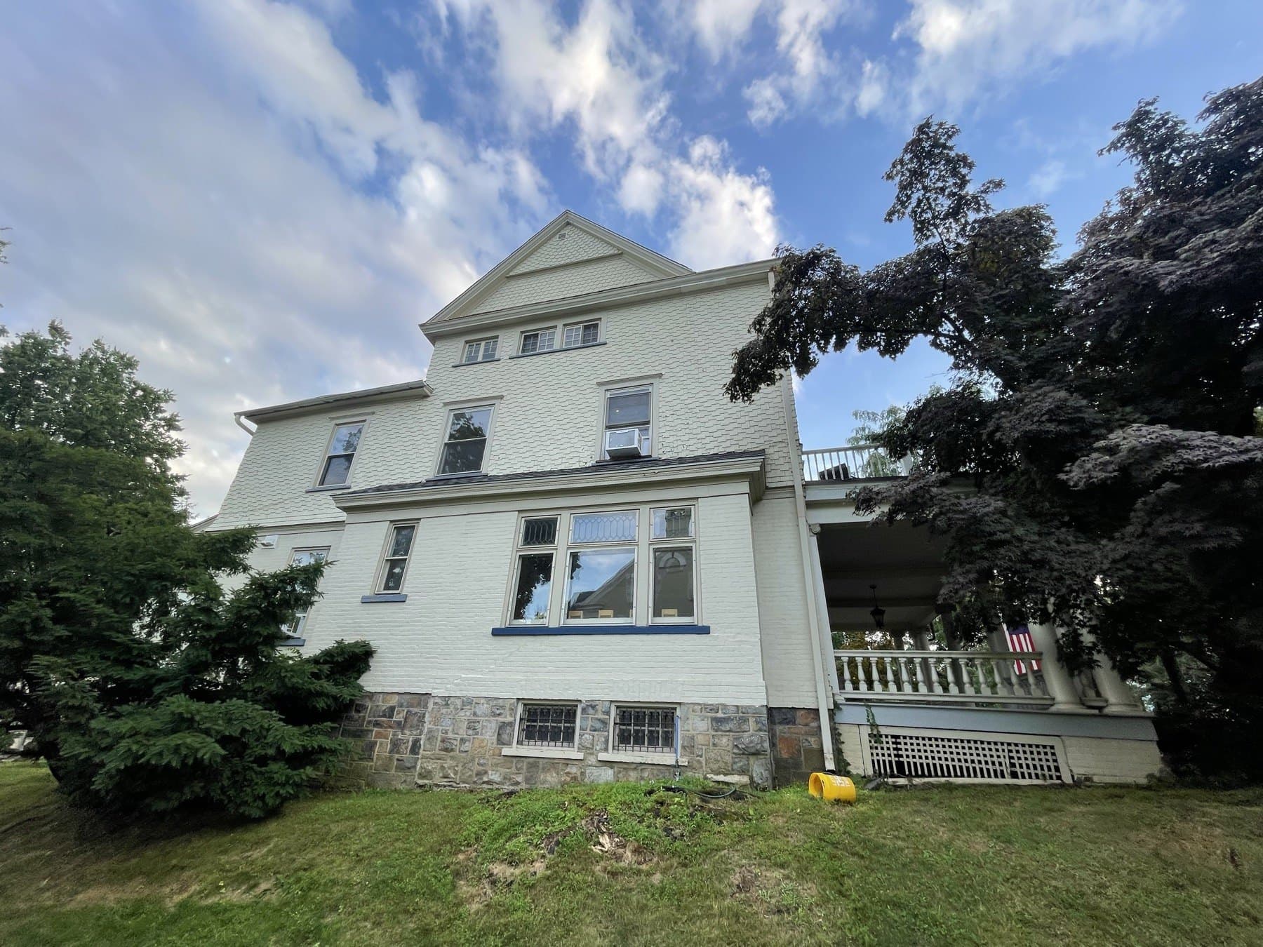 Before photo of Bethlehem house exterior with older paint and blue window trim