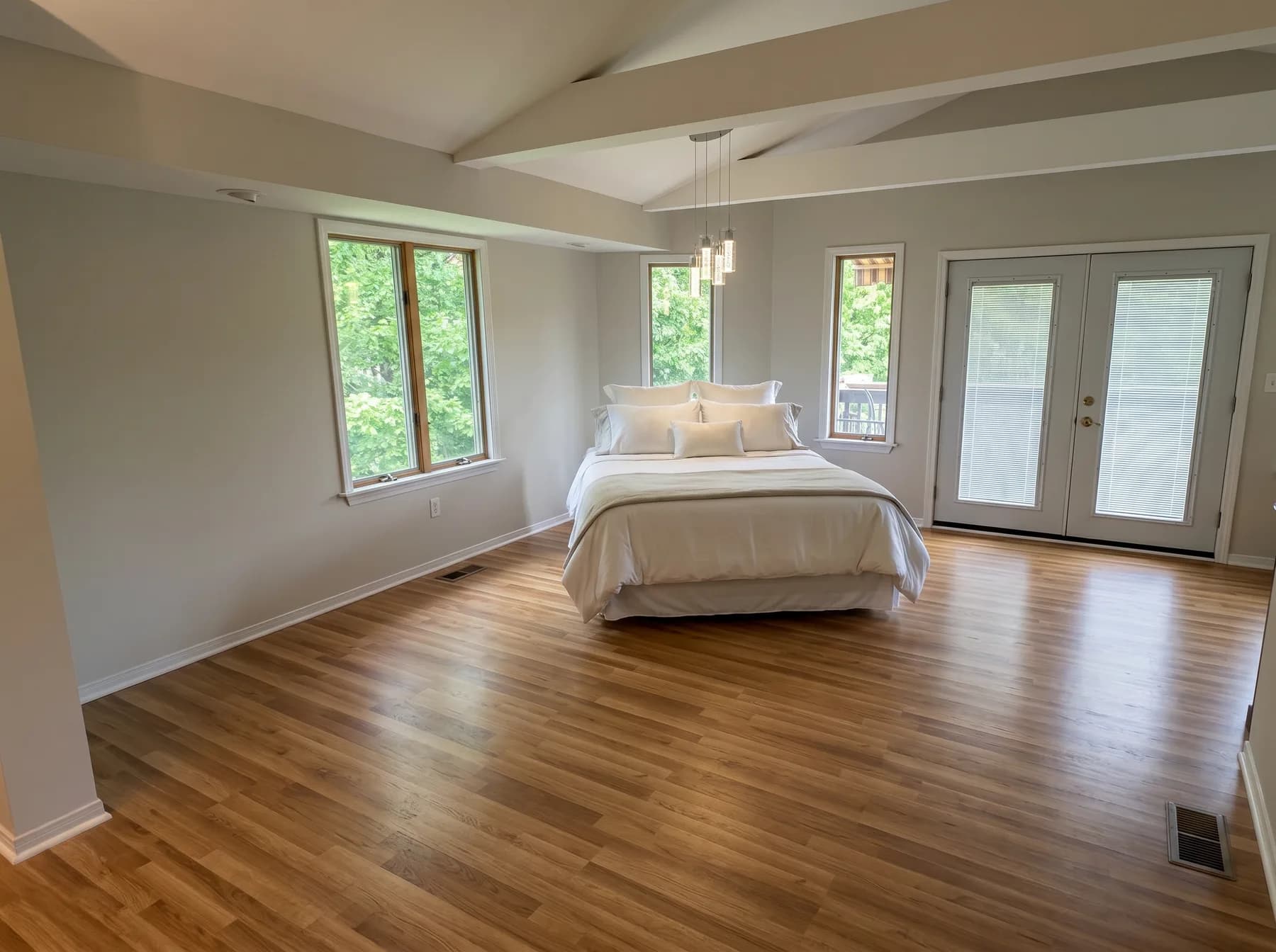 Finished bedroom with natural wood-tone plank flooring in Catasauqua PA