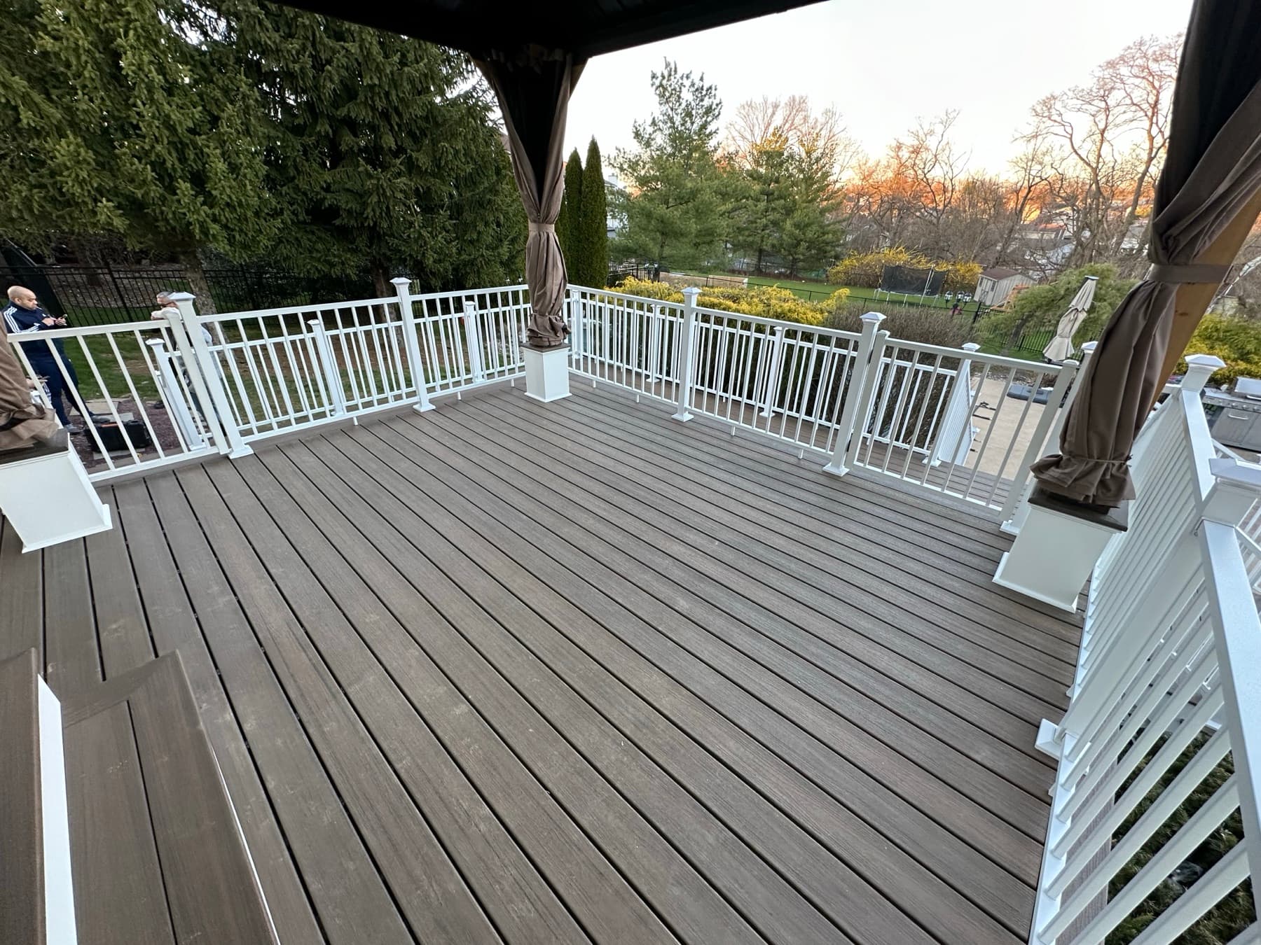 Finished composite PVC deck boards with vinyl railing and covered gazebo in Easton