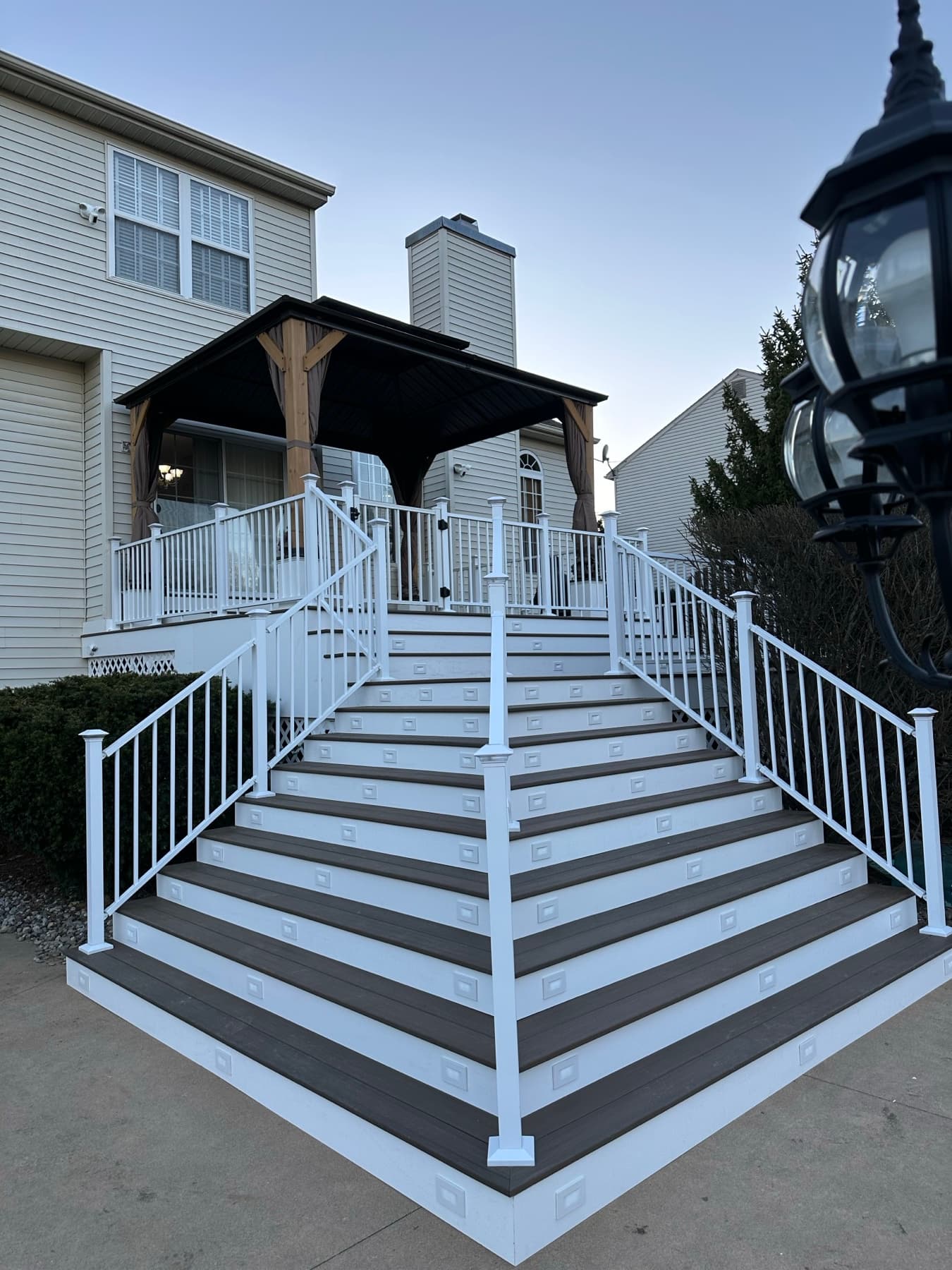 Finished deck stair rebuild with gray treads and white vinyl railings in Easton PA