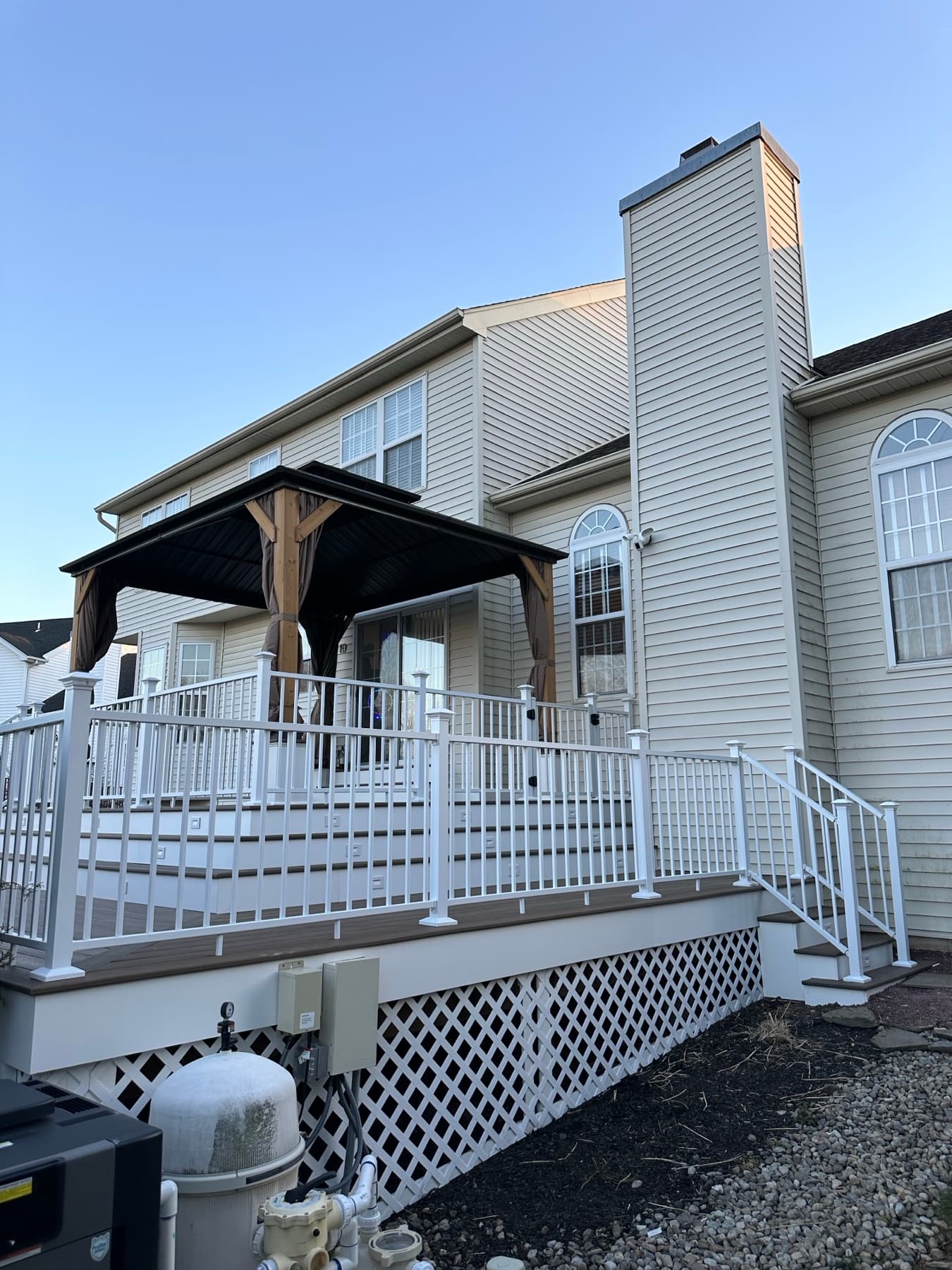 Side view of finished deck with vinyl railing lattice and gazebo in Chestnut Hill Easton