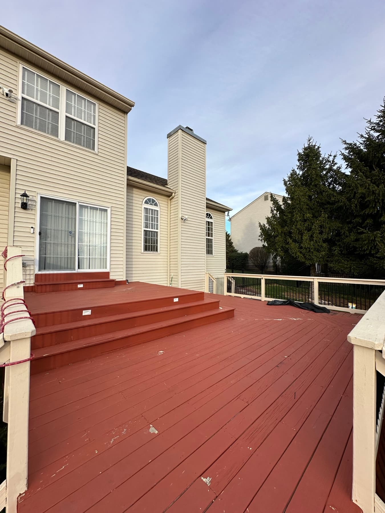 Before photo of red deck landing before a deck renovation in Easton PA