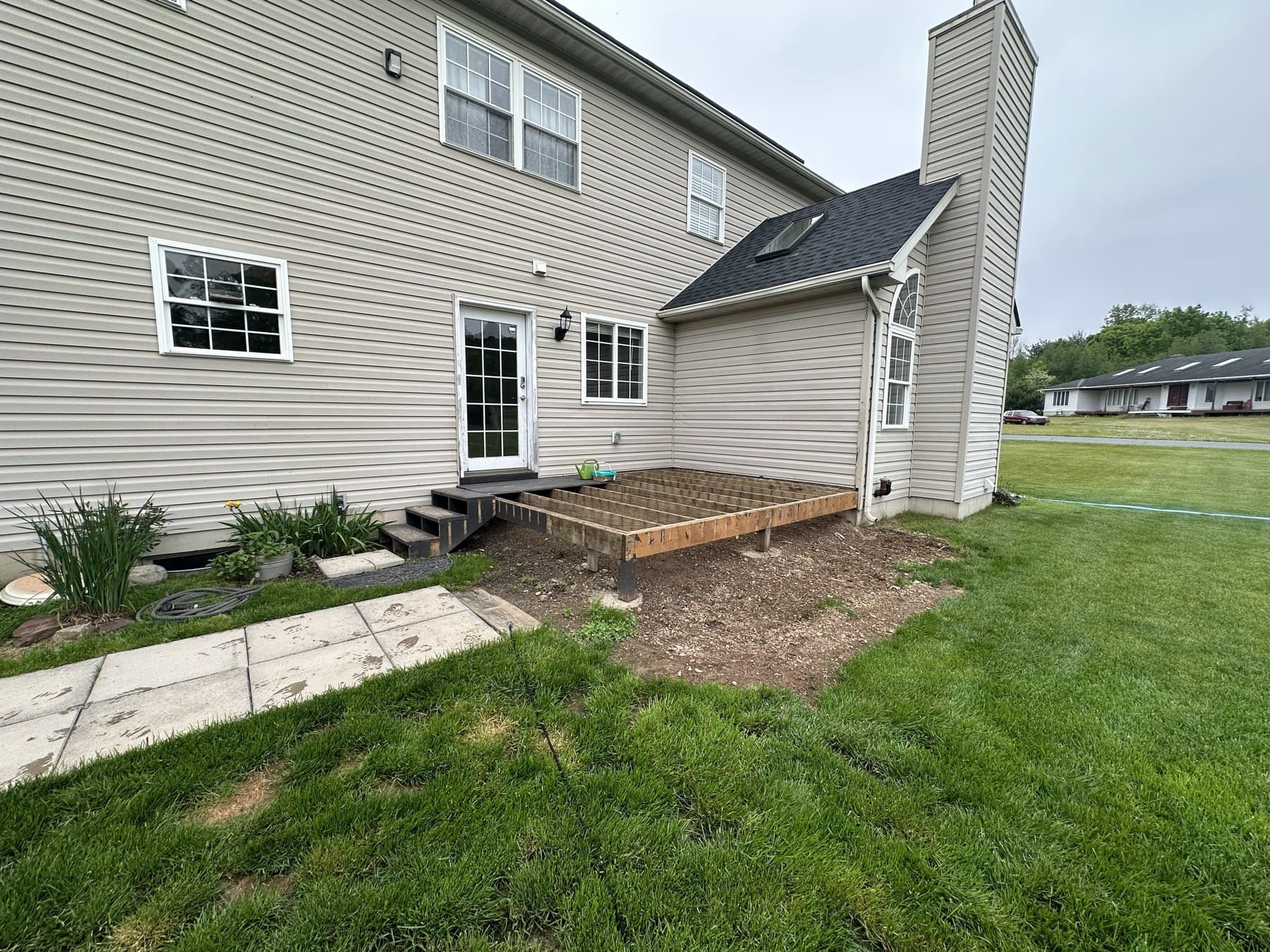 Before photo of backyard patio area before a deck build in Emmaus PA