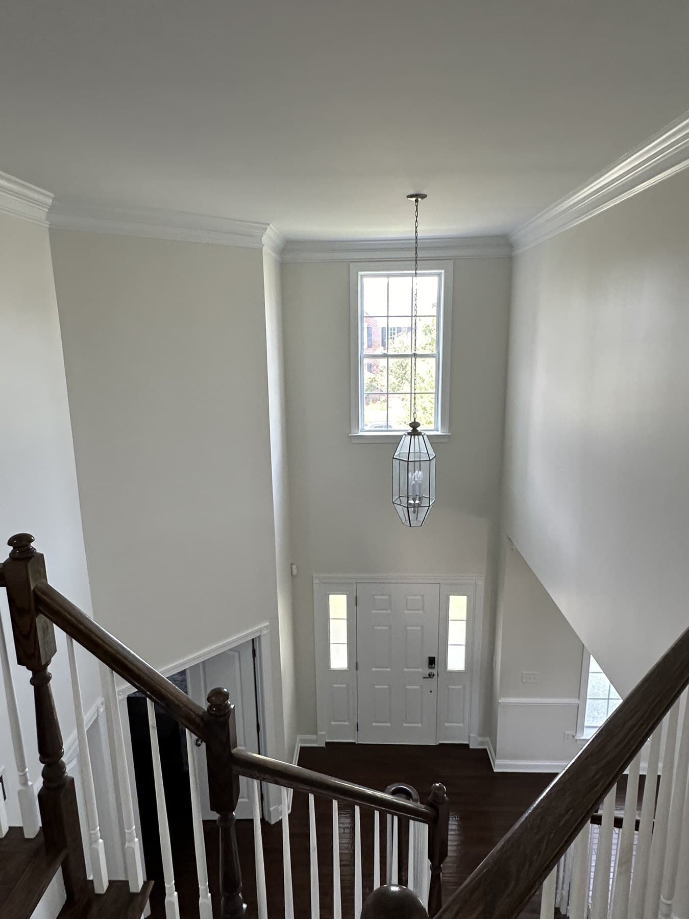 Two-story foyer wall and window after interior painting and trim work in Macungie