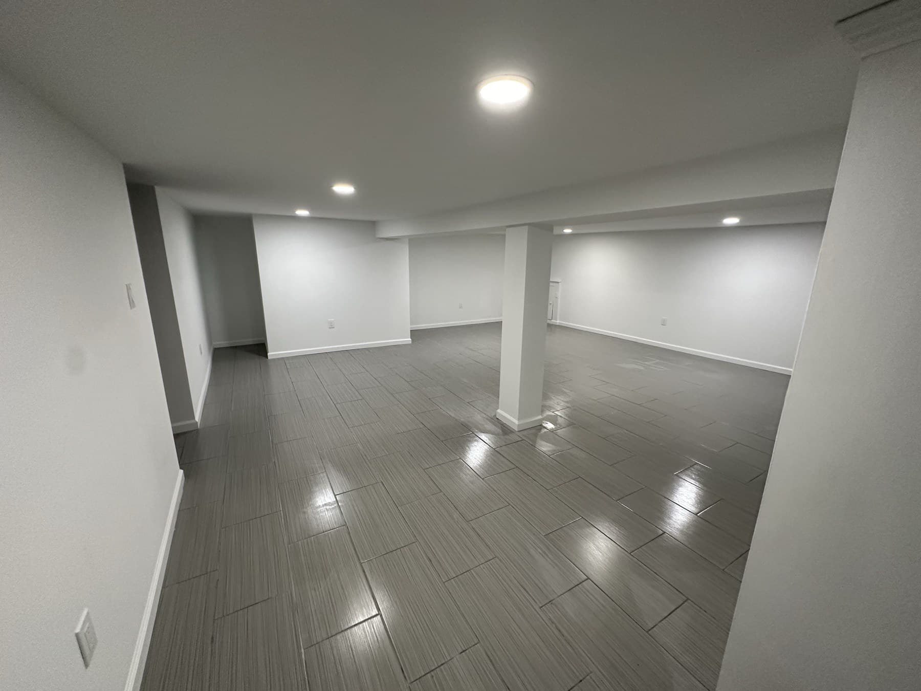 Finished basement with gray tile floor after renovation in Slatington PA