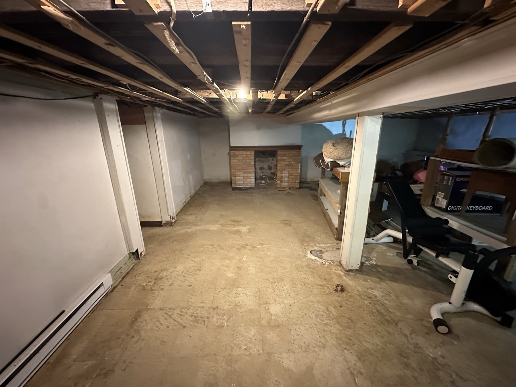 Before photo of basement before framing drywall paint and tile installation in Slatington PA