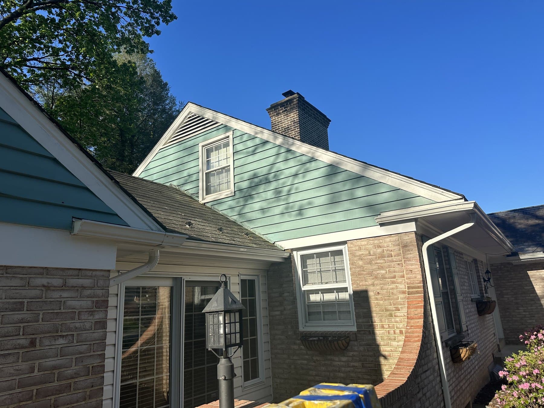 Side elevation during blue green exterior siding painting near Allentown PA