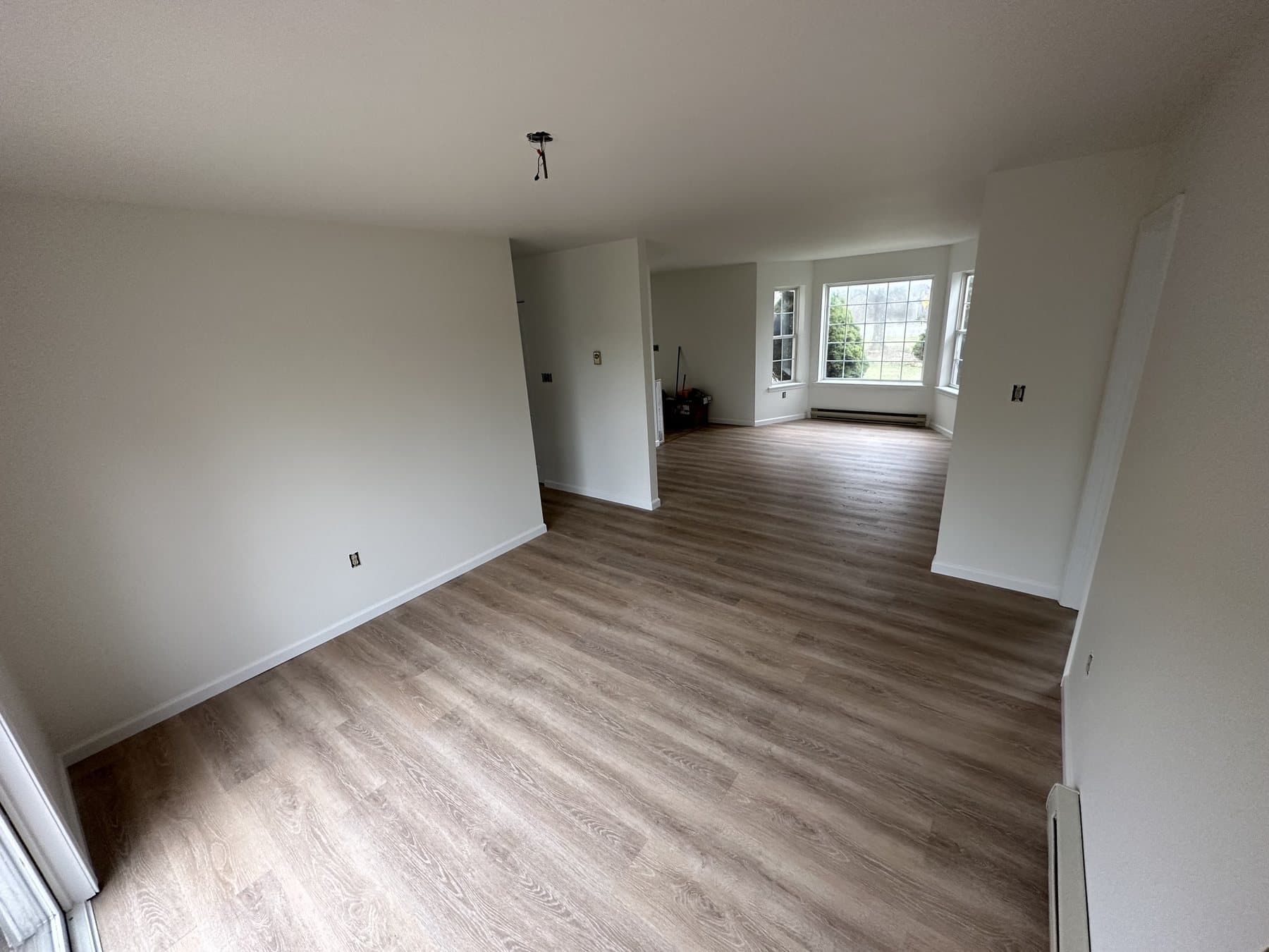 Finished living room with white trim and wood look flooring in Allentown PA
