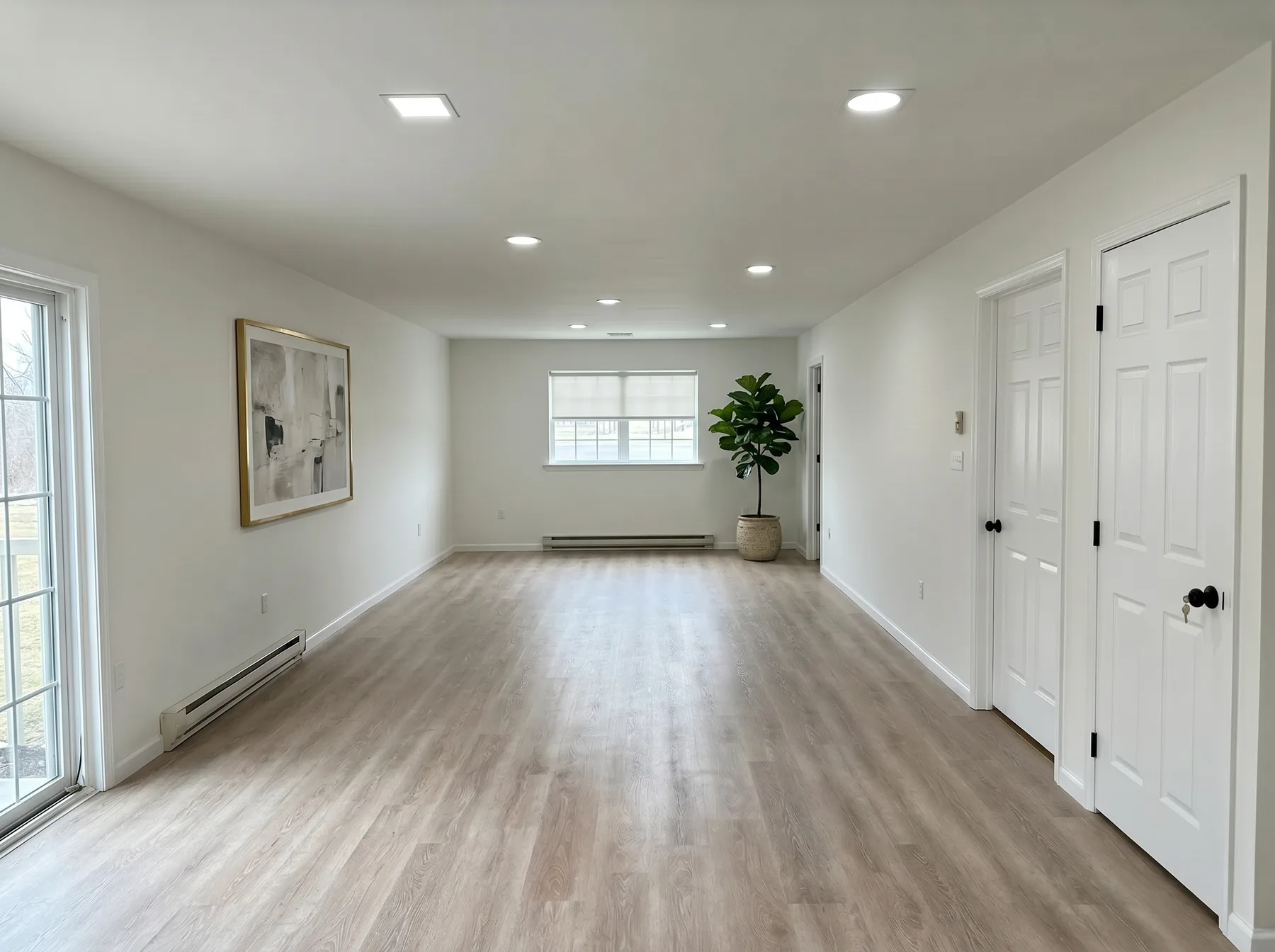 Finished open living area with white trim and wood-look flooring in Southside Allentown