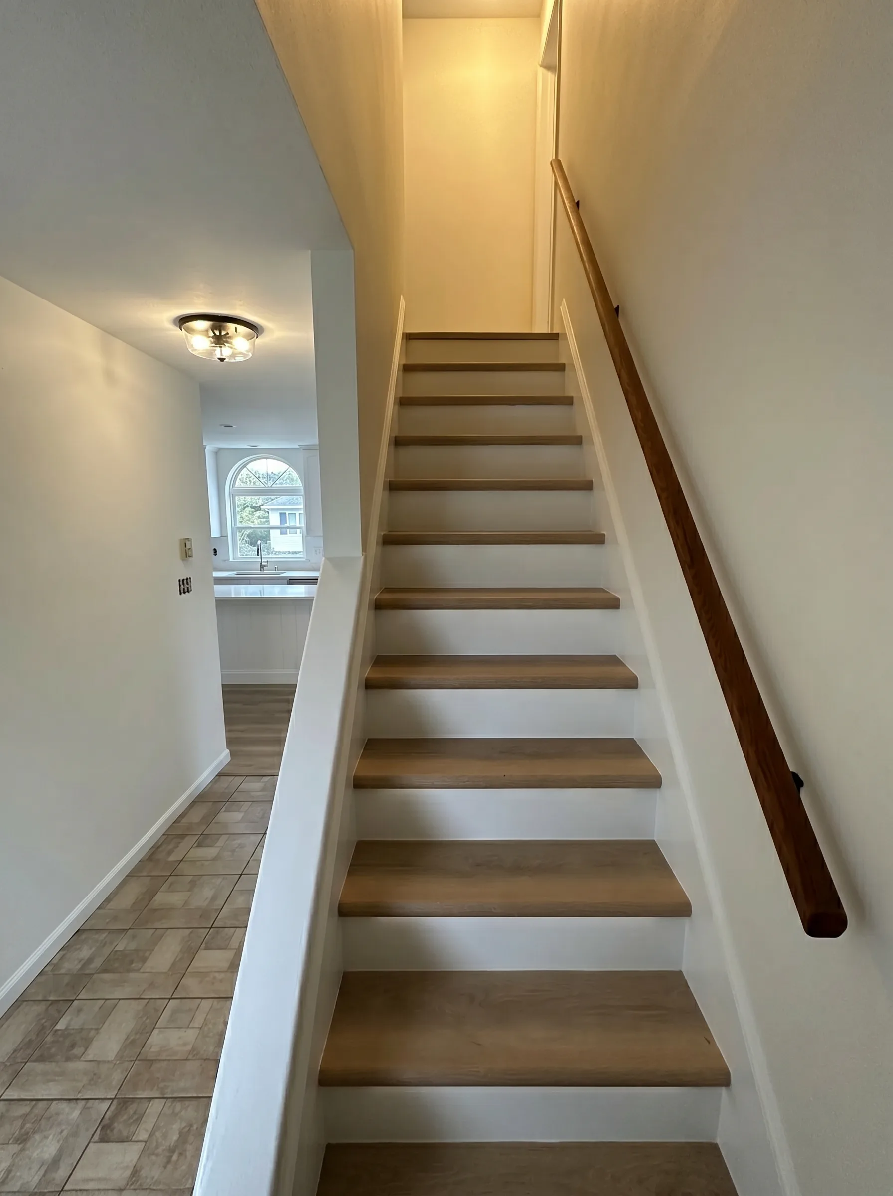 Finished stairs with white risers and wood treads in Southside Allentown
