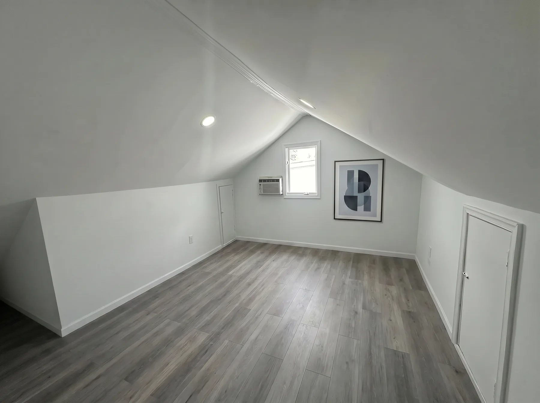 Finished attic room with sloped ceilings and LVP flooring in Westgate Hills Bethlehem