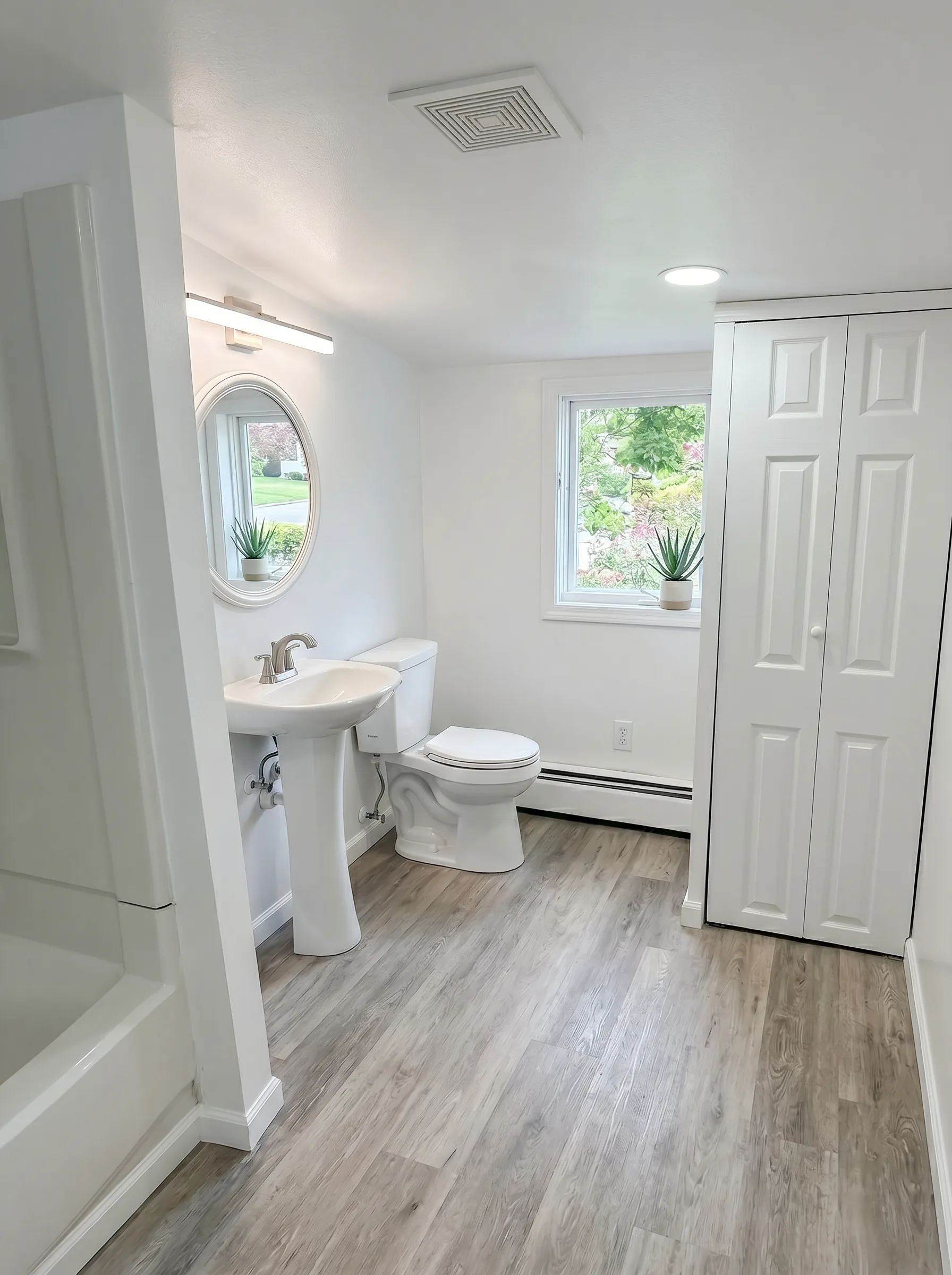 Finished bathroom with pedestal sink and LVP flooring in Bethlehem