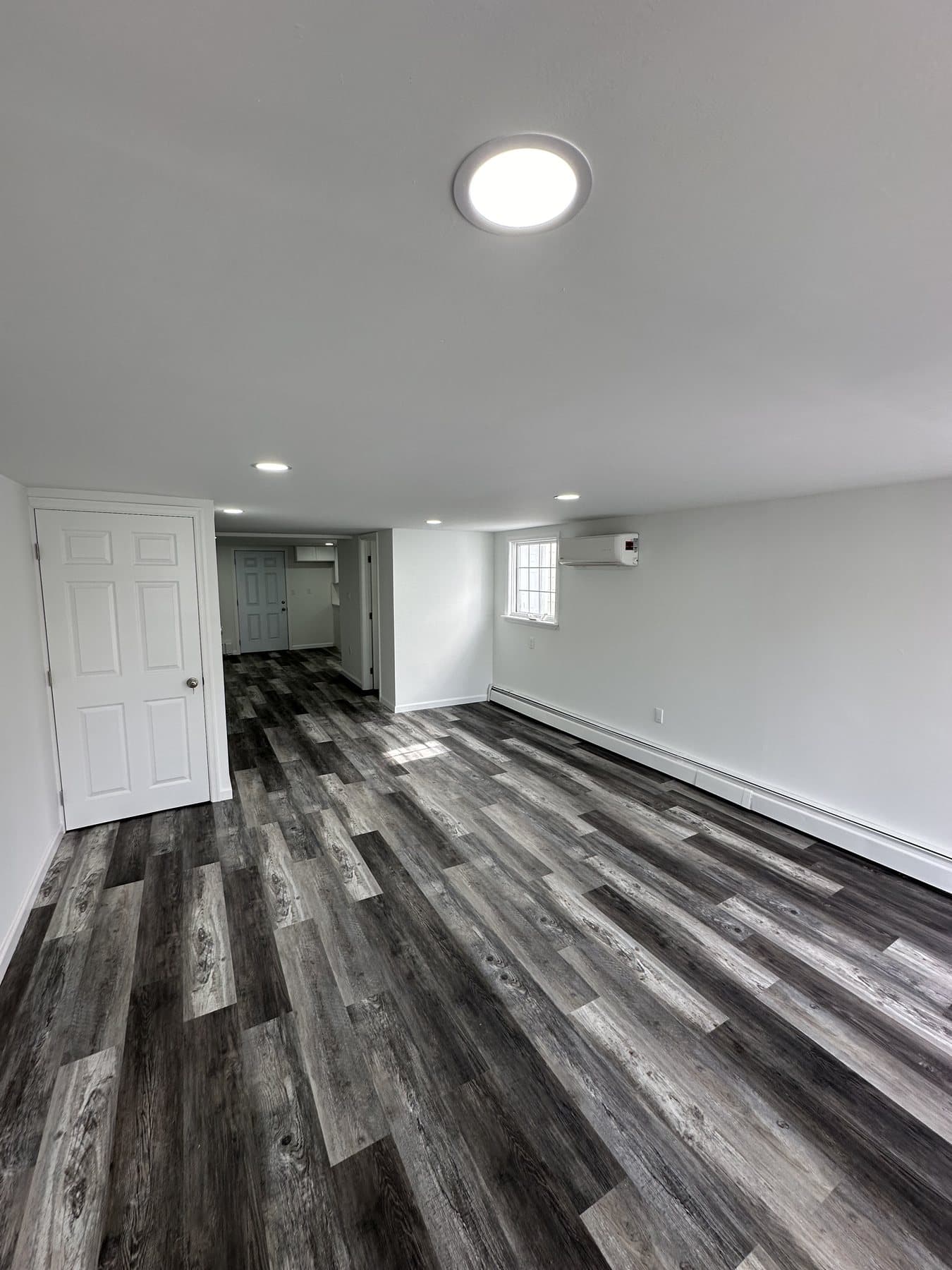 Finished open room with LVP flooring and recessed lights in Bethlehem