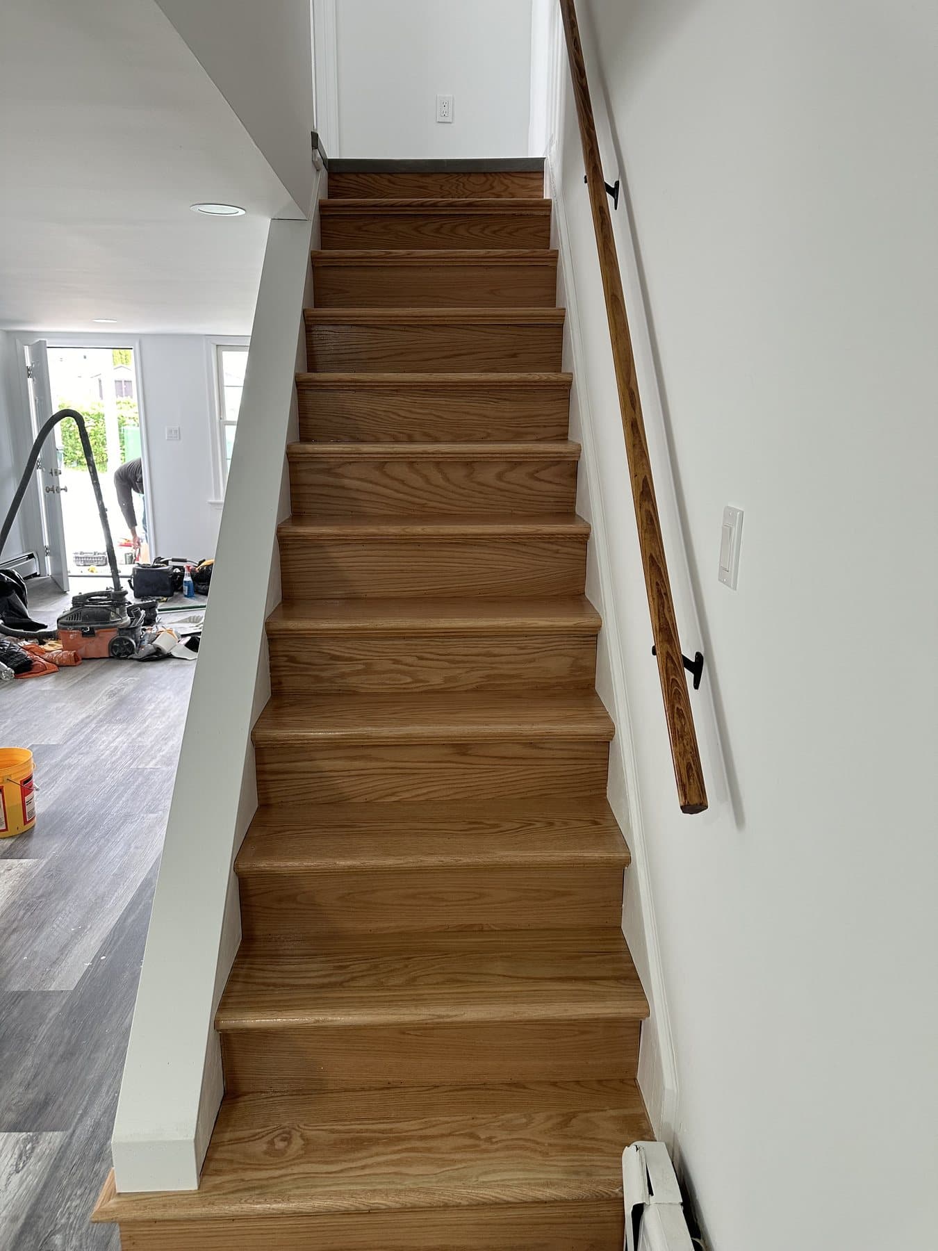 Finished stairs with wood treads and handrail in Bethlehem house renovation