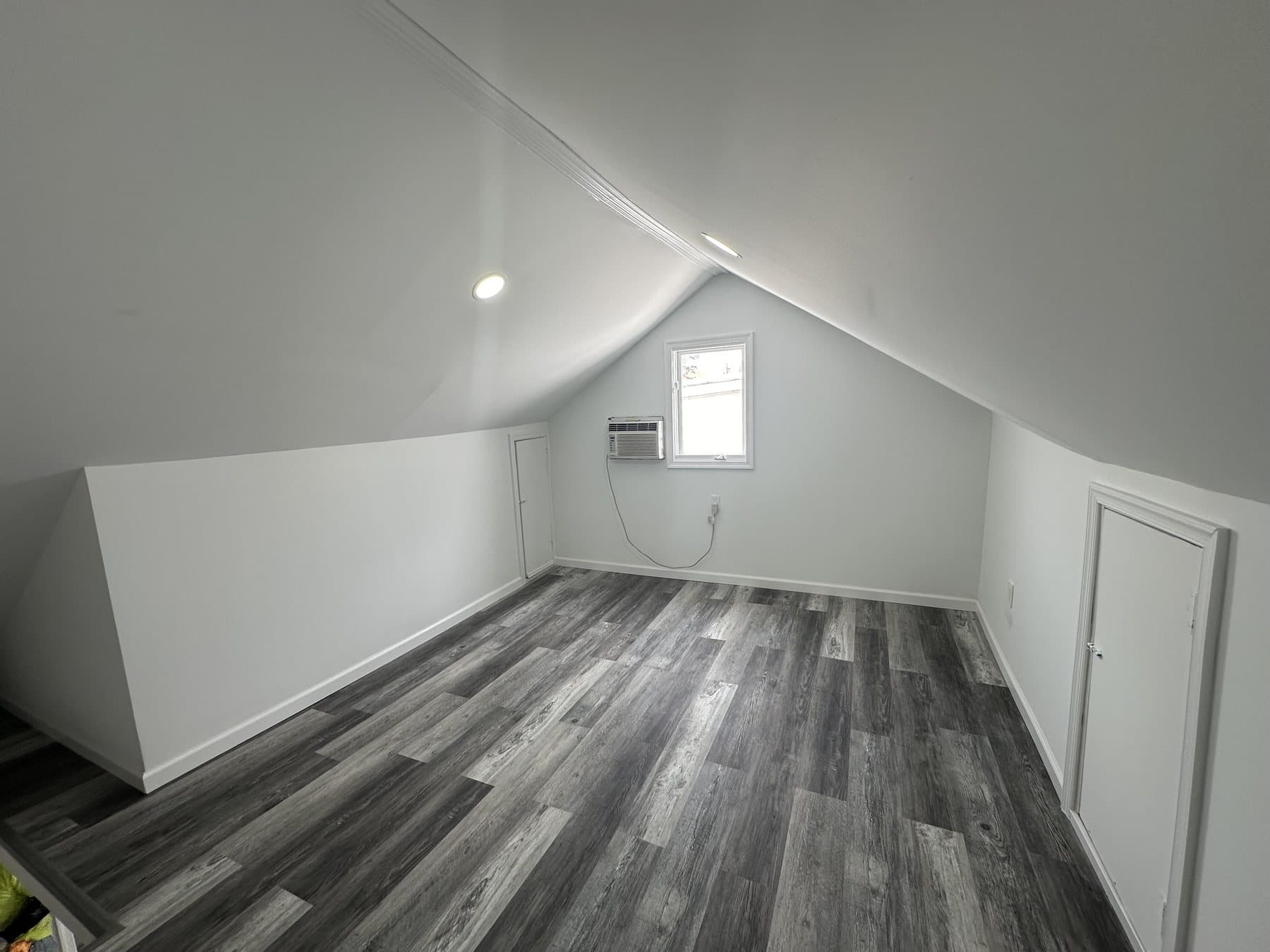 Finished upper-floor room with recessed lighting and LVP flooring in Bethlehem
