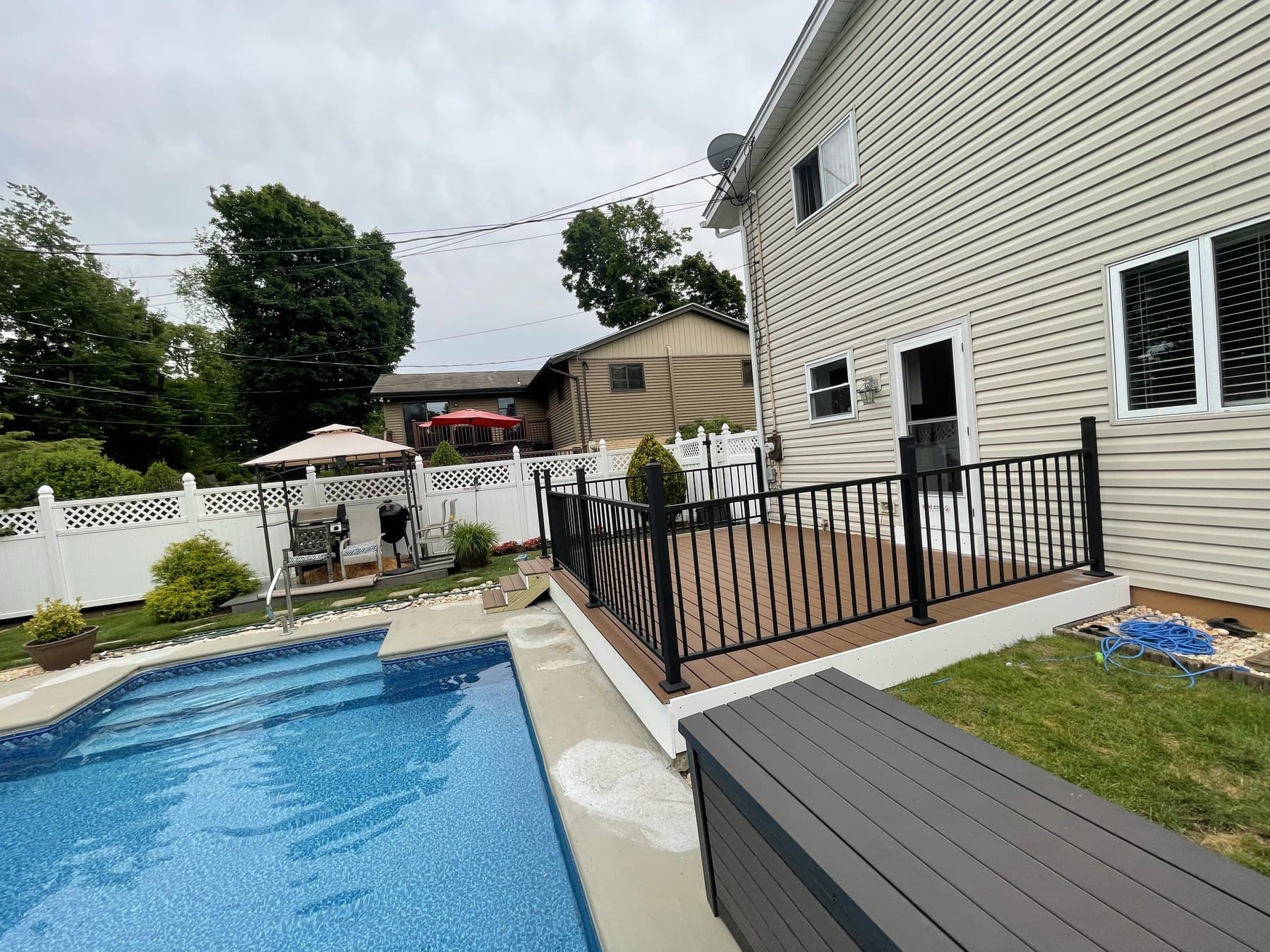 Side yard view of finished poolside deck and railing in Hellertown PA