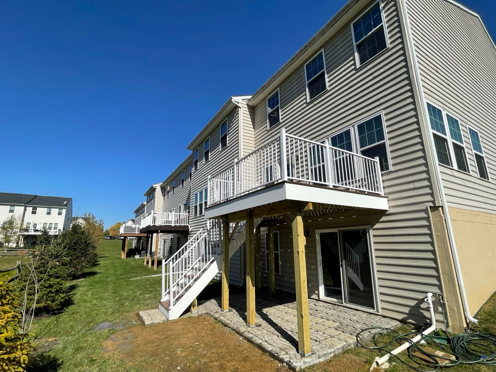 Side yard view of finished elevated deck and stair build in Macungie