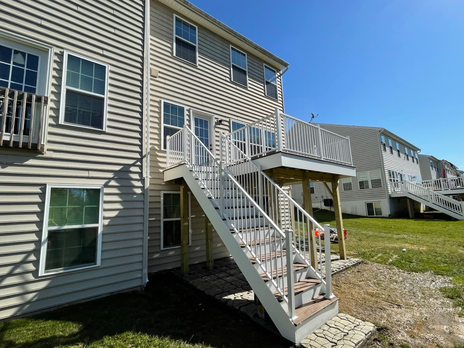 Finished elevated deck with white railing and stairs in Macungie PA