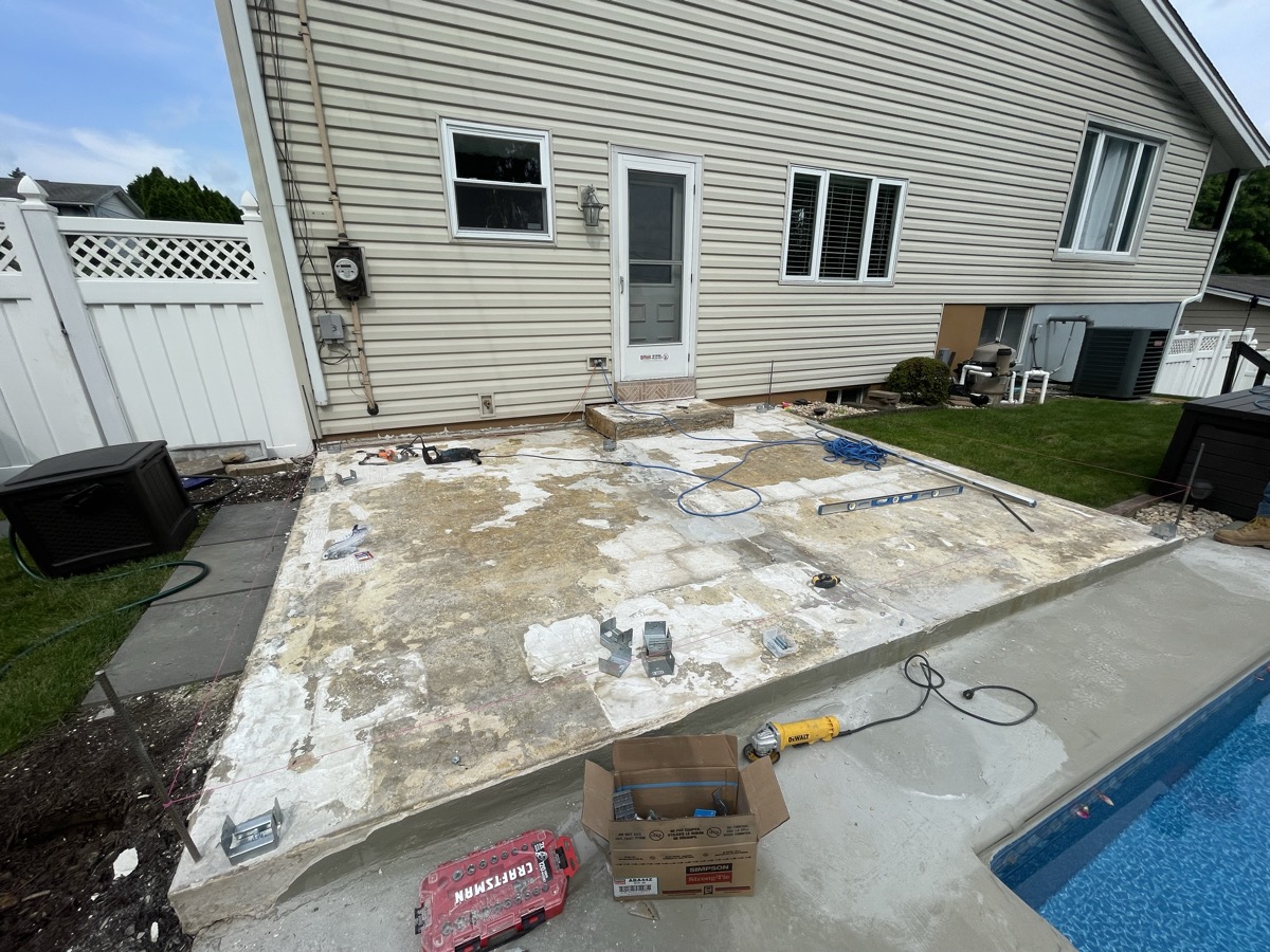 Backyard poolside deck area during construction