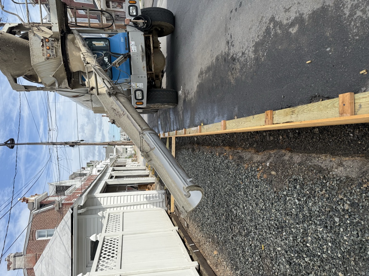 Side-yard path under construction beside a house