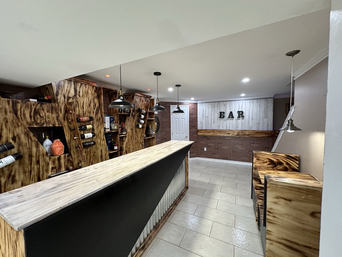 Finished basement bar with wood wall detailing