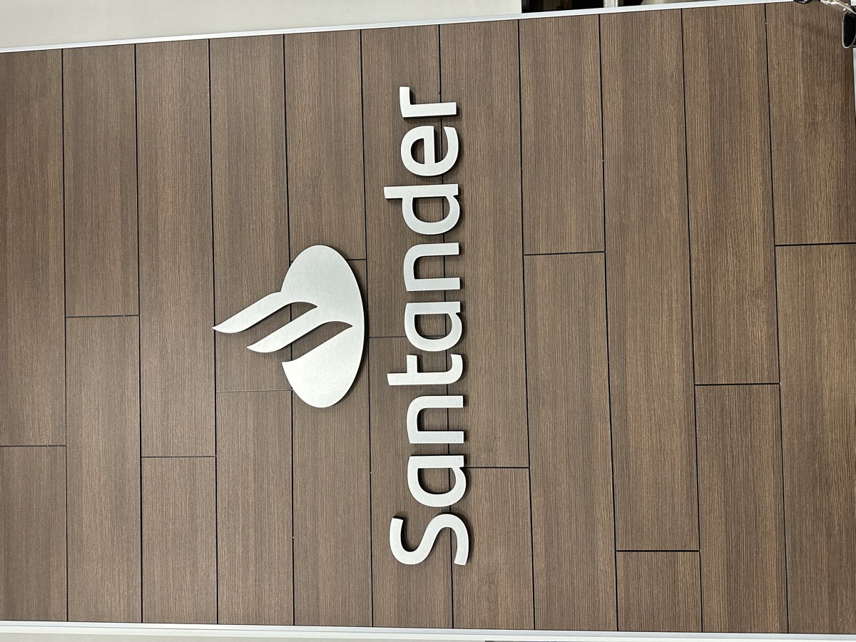Santander feature wall with finished wood-look surface and brand sign