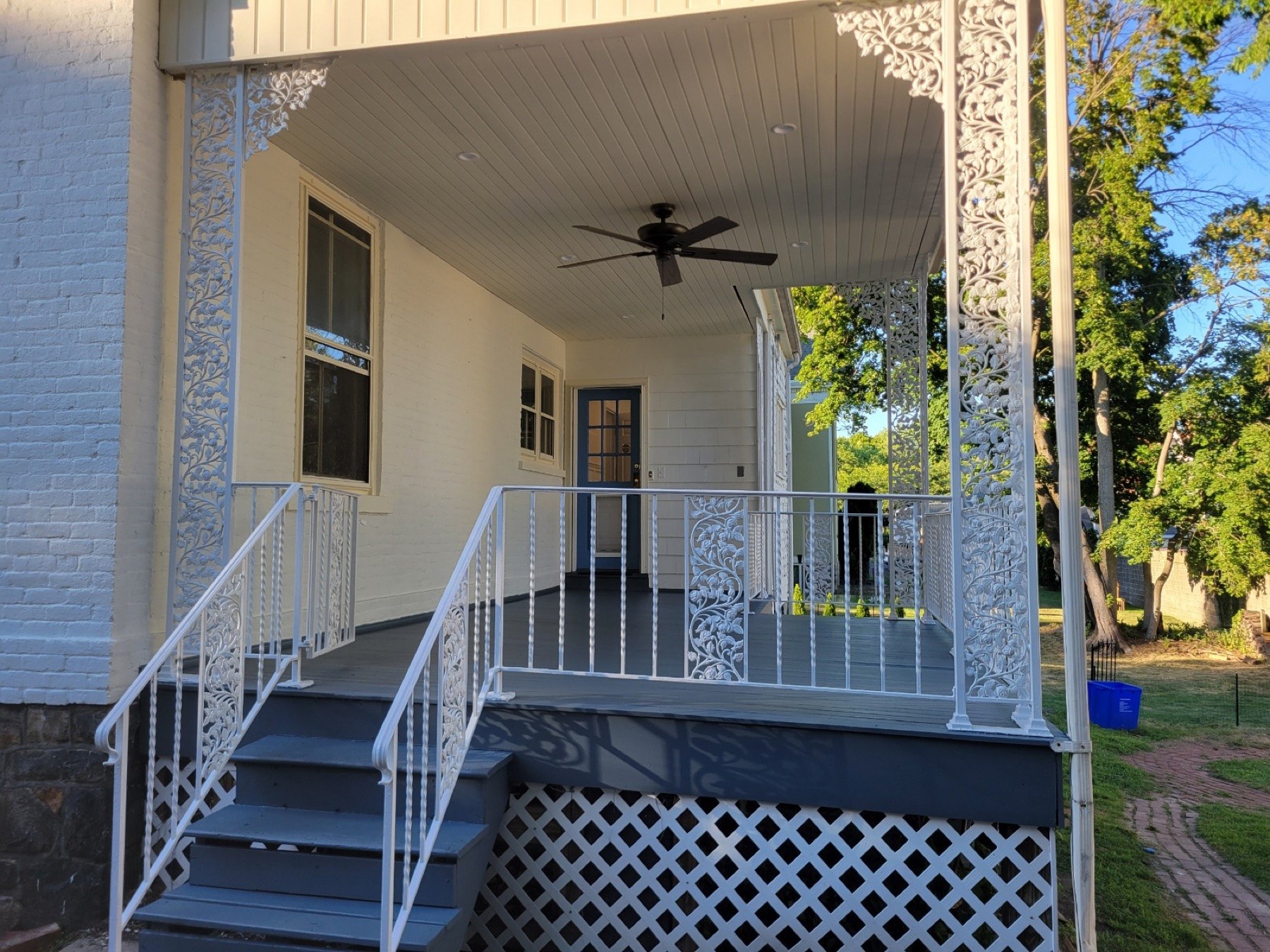 Finished Bethlehem porch with gray floor white railings and refreshed exterior paint
