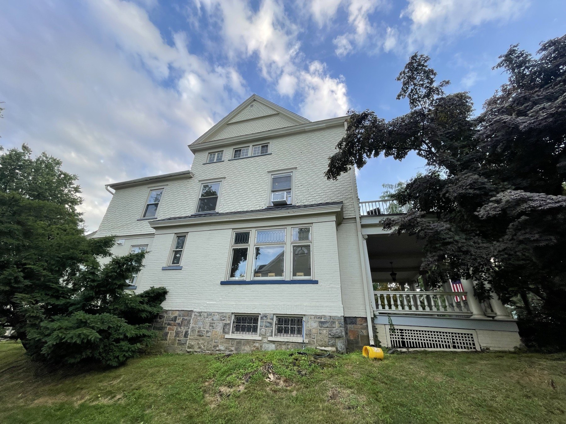 Before photo of Bethlehem house exterior with older paint and blue window trim