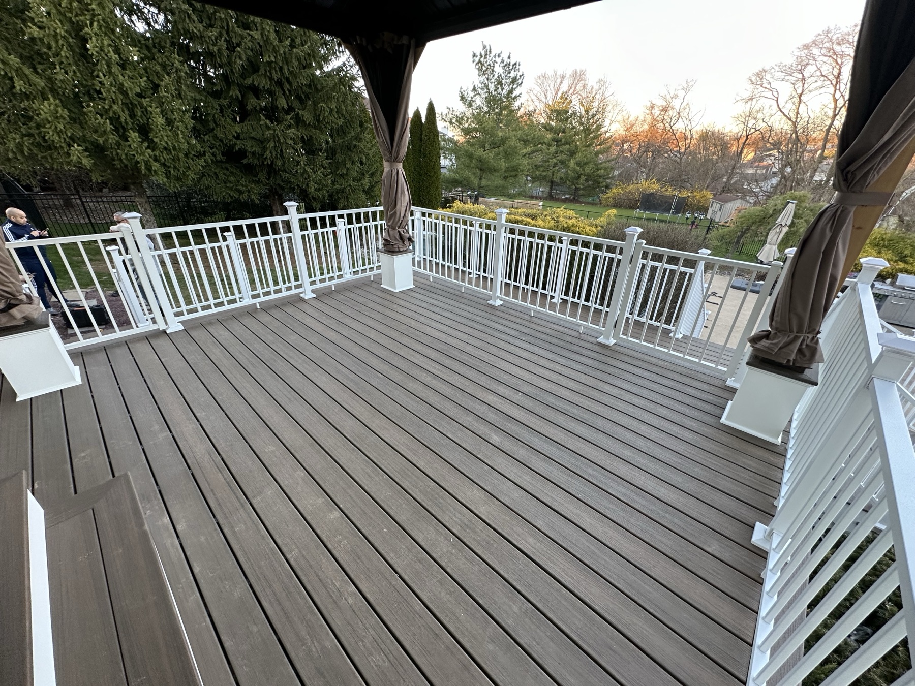 Finished composite PVC deck boards with vinyl railing and covered gazebo in Easton