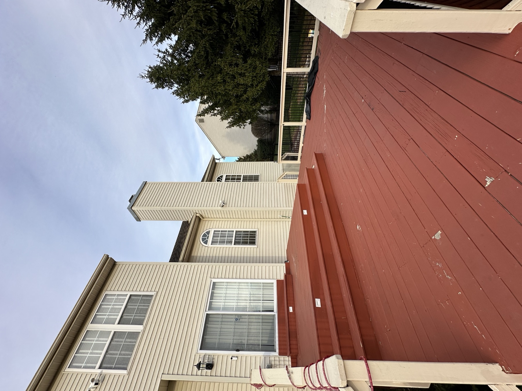 Before photo of red deck landing before a deck renovation in Easton PA
