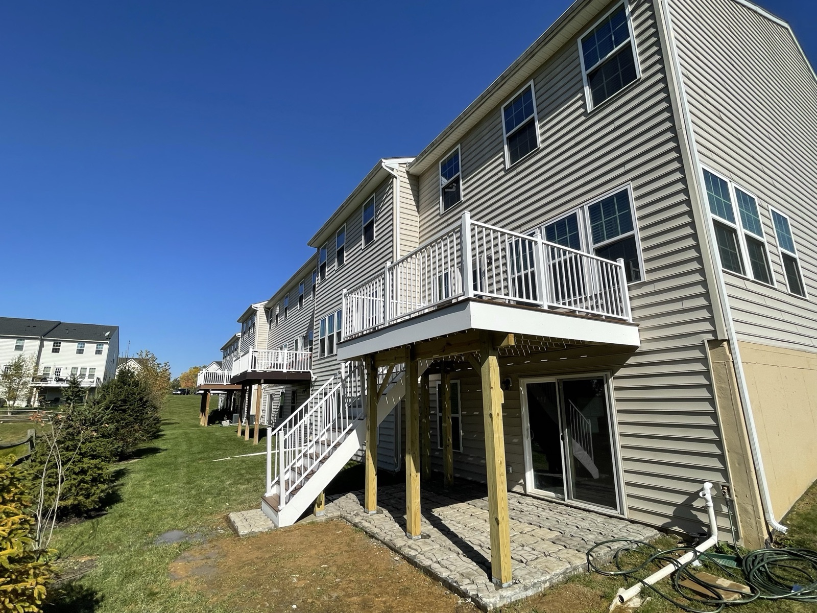 Side yard view of finished elevated deck and stair build in Macungie