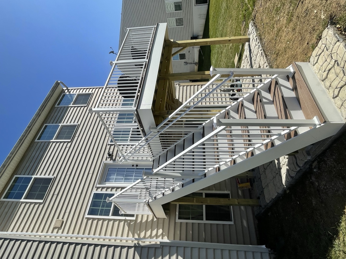 Close view of white deck railing and stair treads after a Macungie deck build