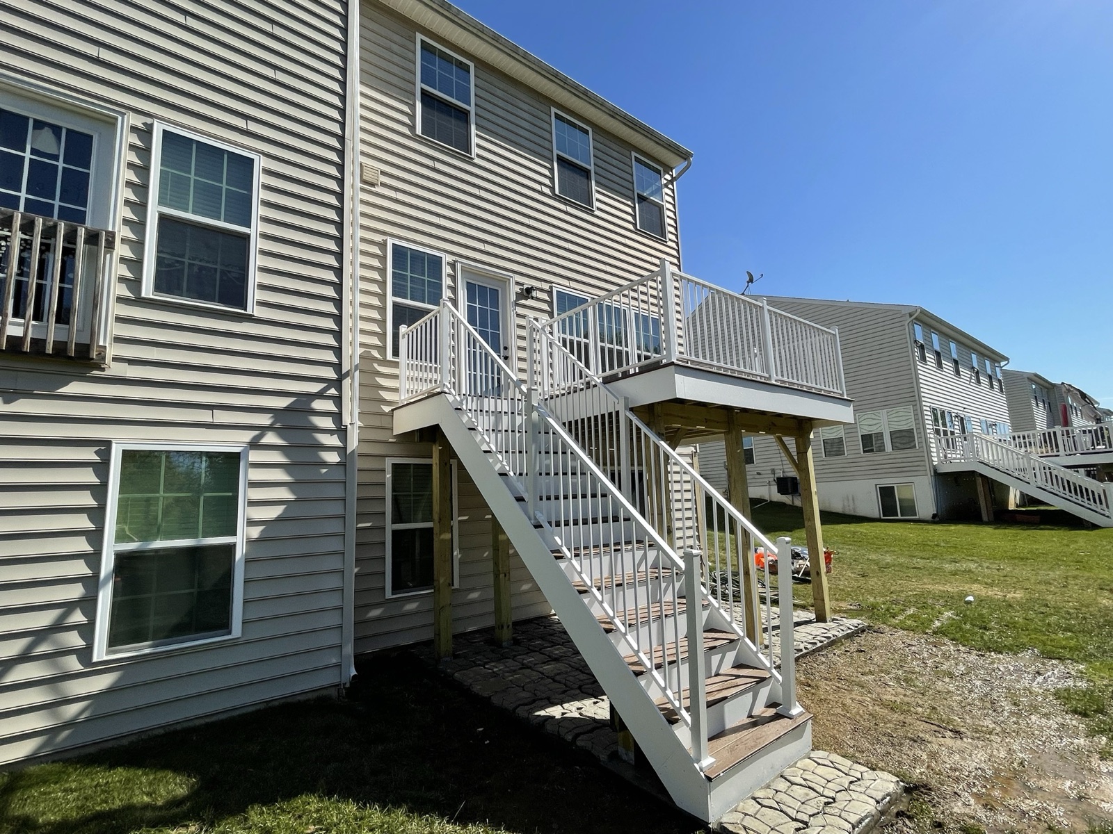 Finished elevated deck with white railing and stairs in Macungie PA