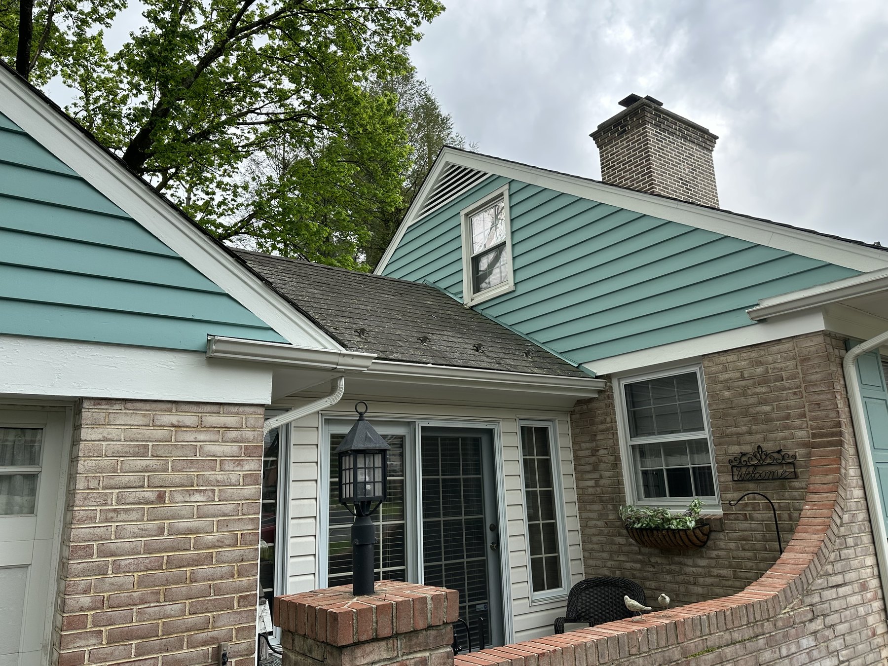 Finished house entry with blue green siding and white trim in Allentown PA