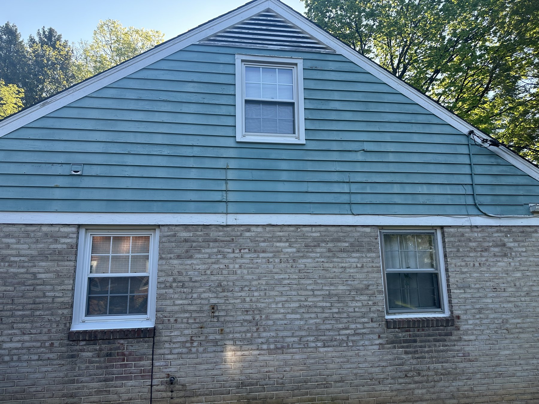 Before photo of weathered blue green siding and white trim near Allentown PA