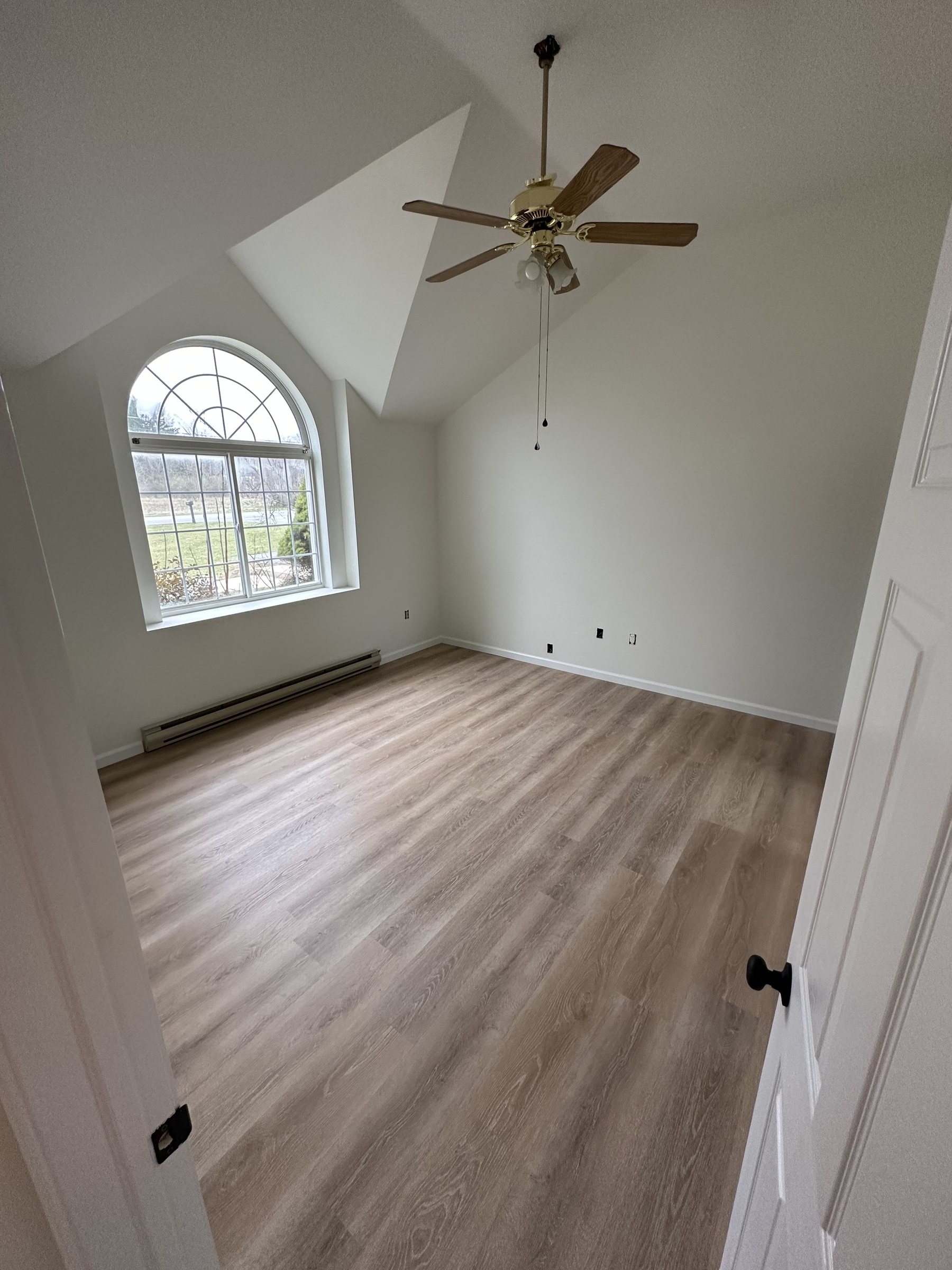 Finished bedroom with light walls and refreshed flooring in Southside Allentown
