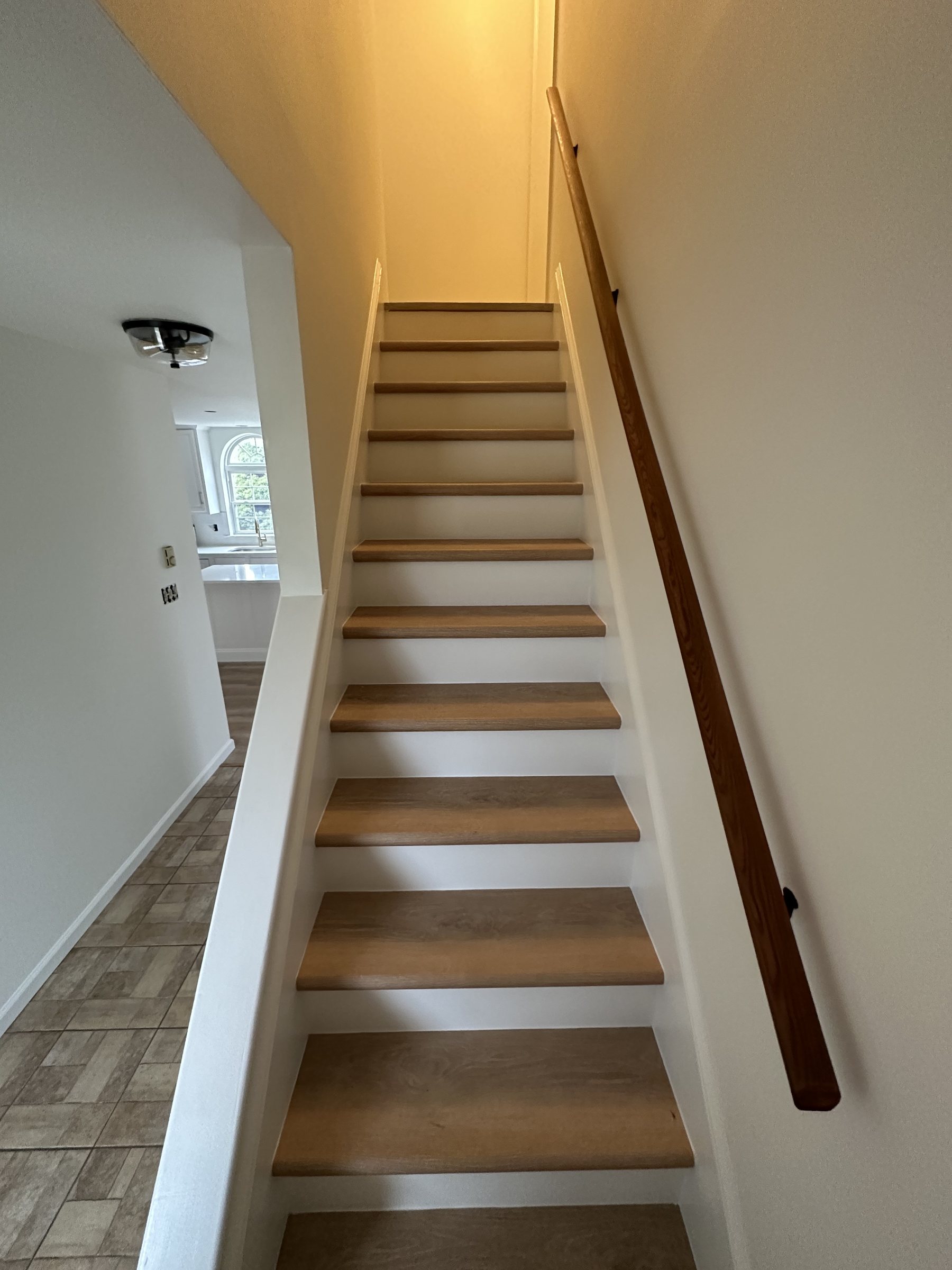 Finished stairs with white risers and wood treads in Southside Allentown