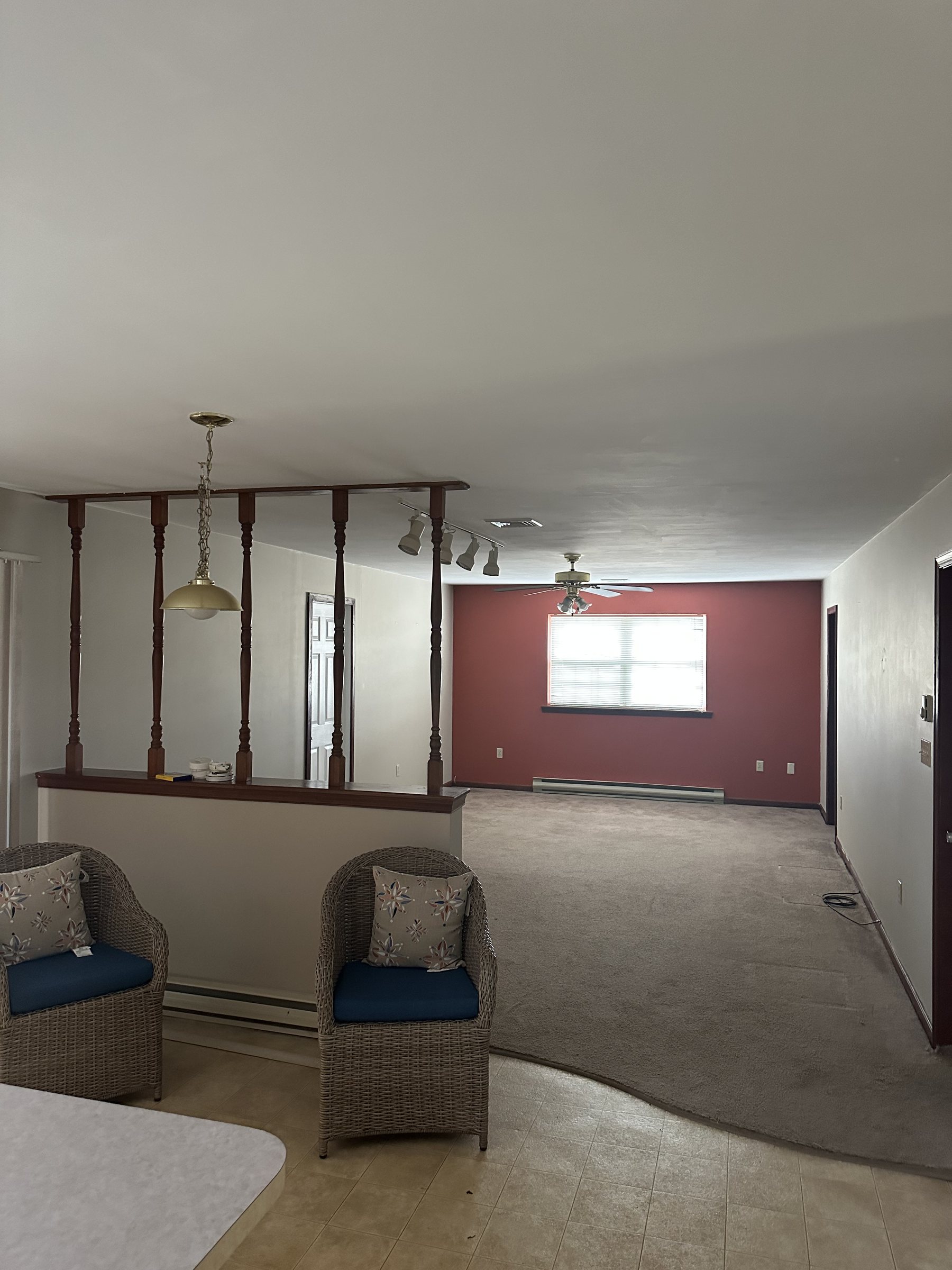 Before photo of carpeted main room before an interior renovation in Southside Allentown