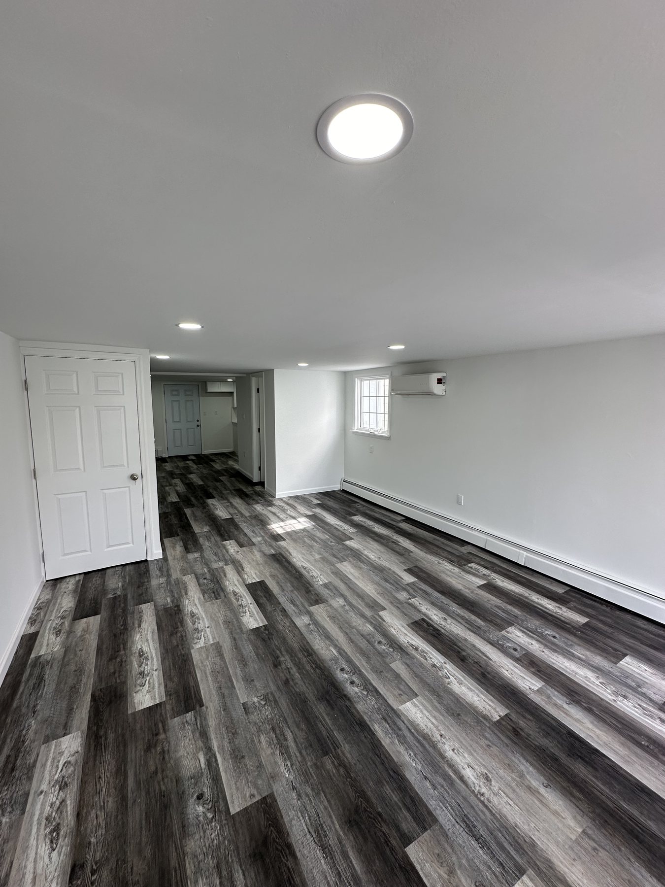 Finished open room with LVP flooring and recessed lights in Bethlehem