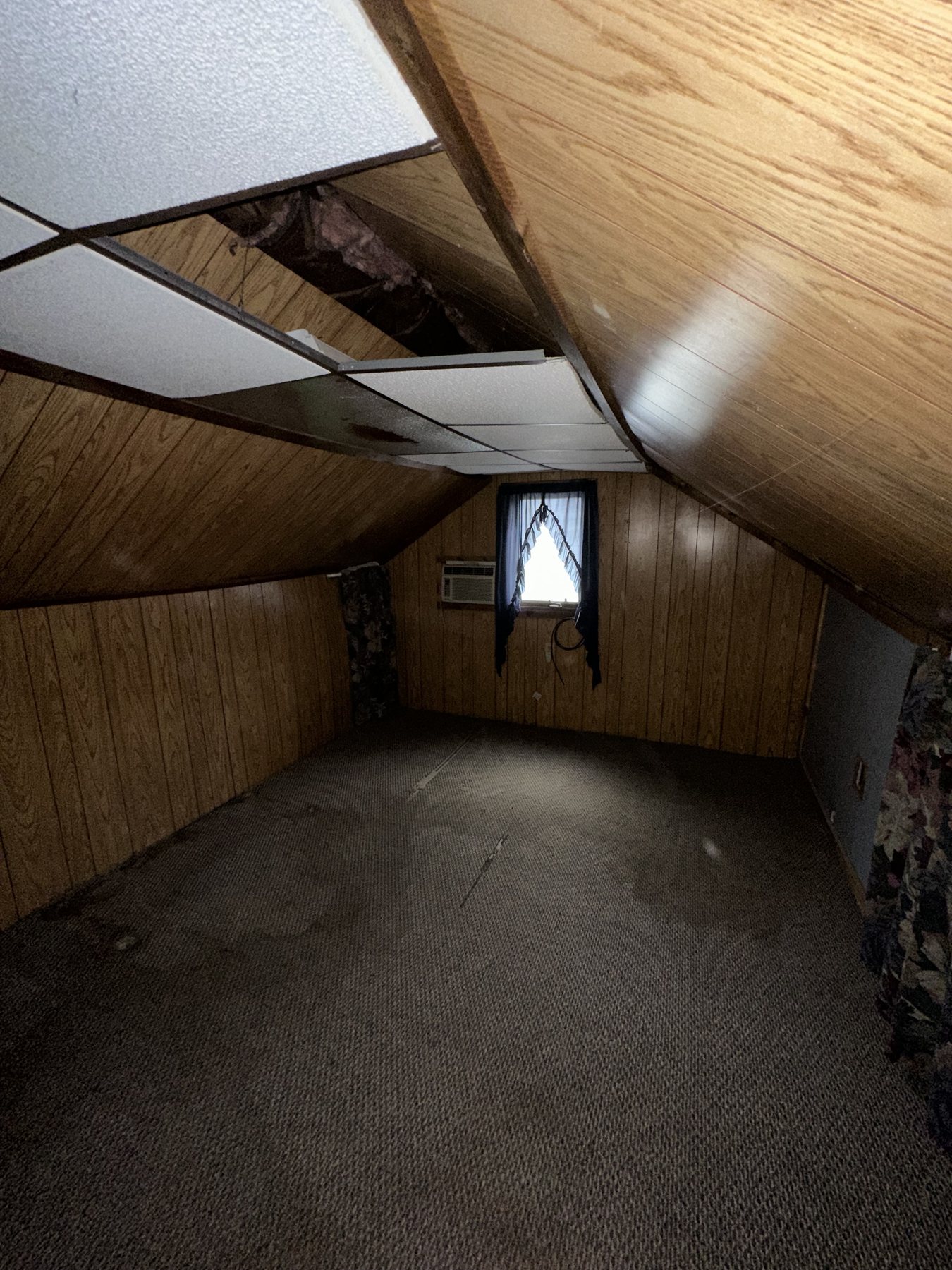 Before photo of upper-floor room with wood paneling in Westgate Hills Bethlehem